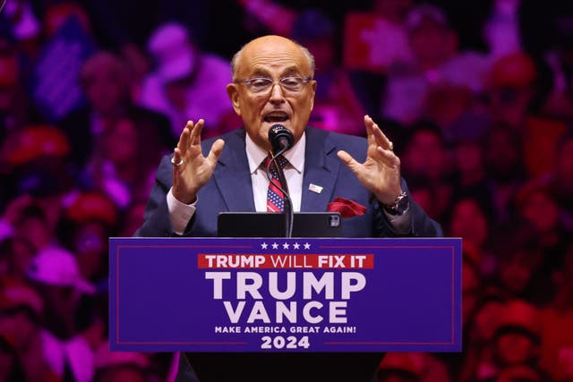 <p>Rudy Giuliani addresses a crowd inside Madison Square Garden on October 27. </p>