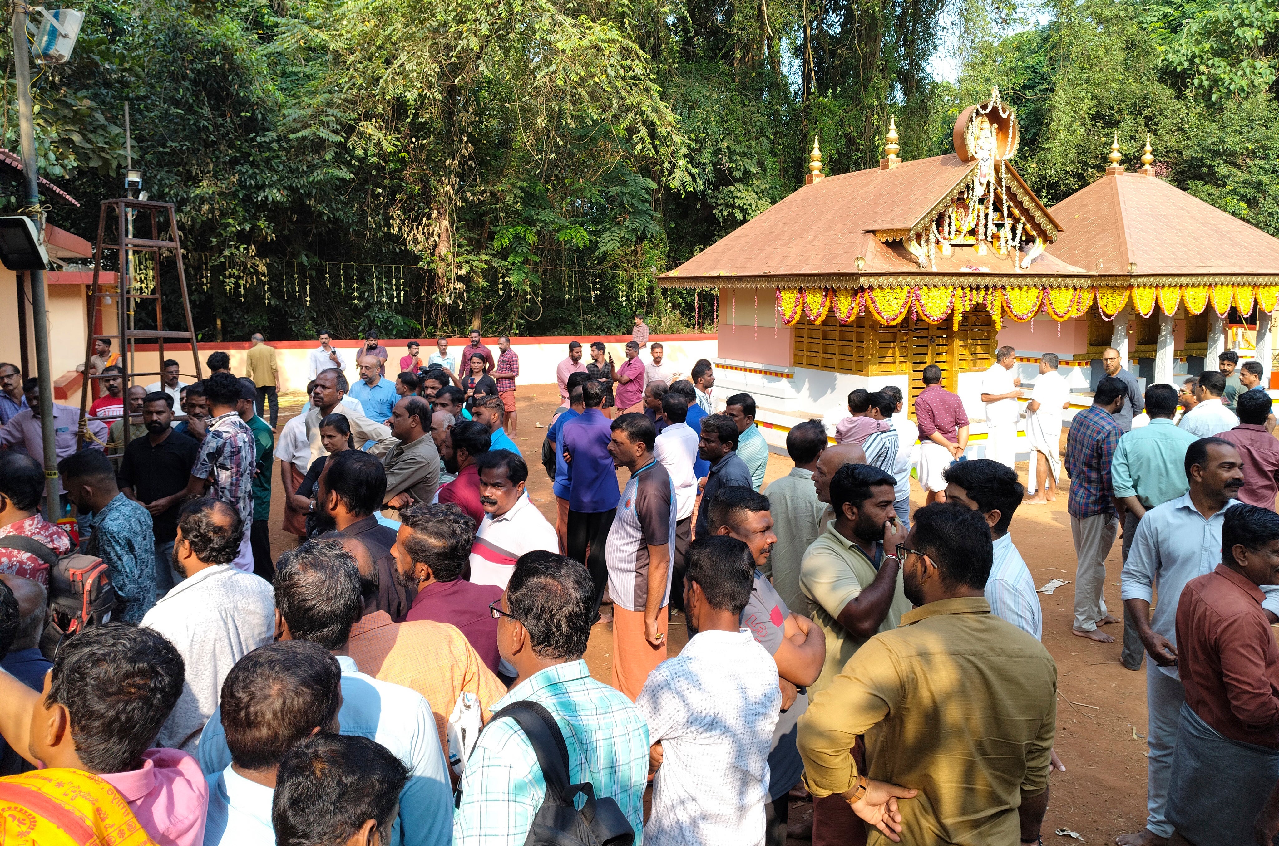 People gather at the Veerarkavu temple where a fireworks explosion occurred on Monday night in Kerala, India