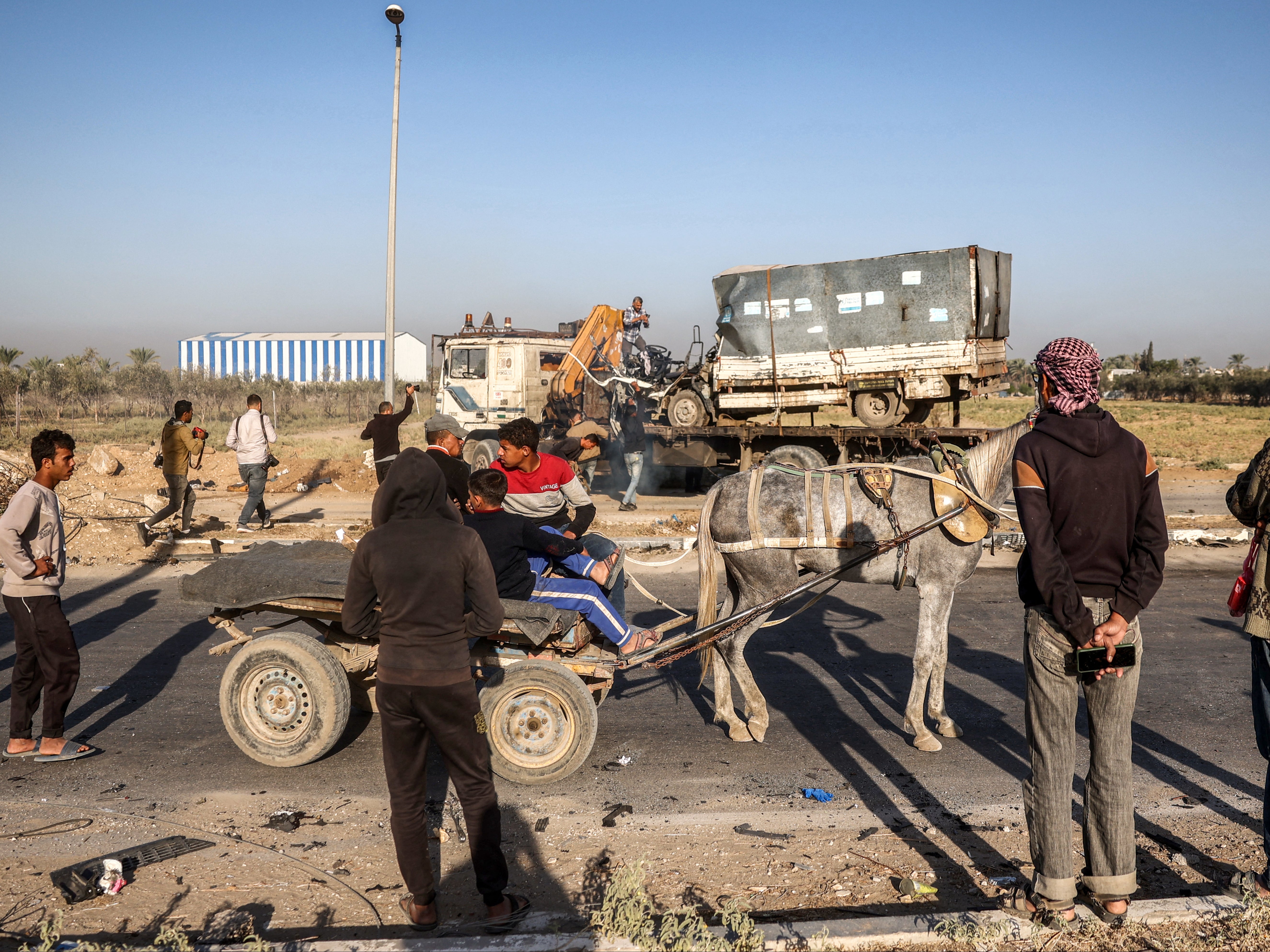 A donkey-drawn cart arrives along Gaza’s main Salah al-Din road outside Deir el-Balah in the centre of the Gaza Strip on 23 October 2024