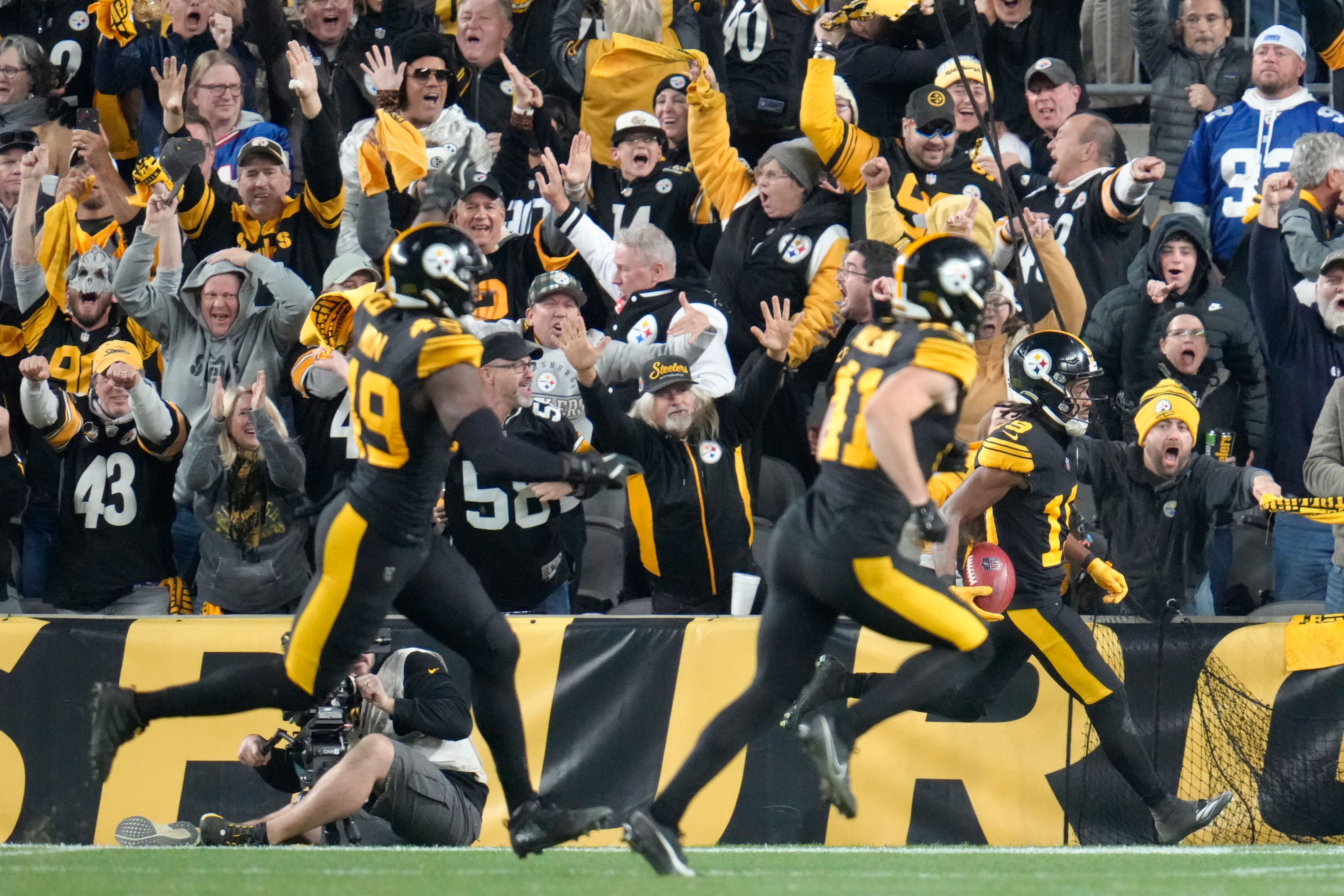 Pittsburgh Steelers wide receiver Calvin Austin III (right) returns a punt for a touchdown (Gene J Puskar/AP)