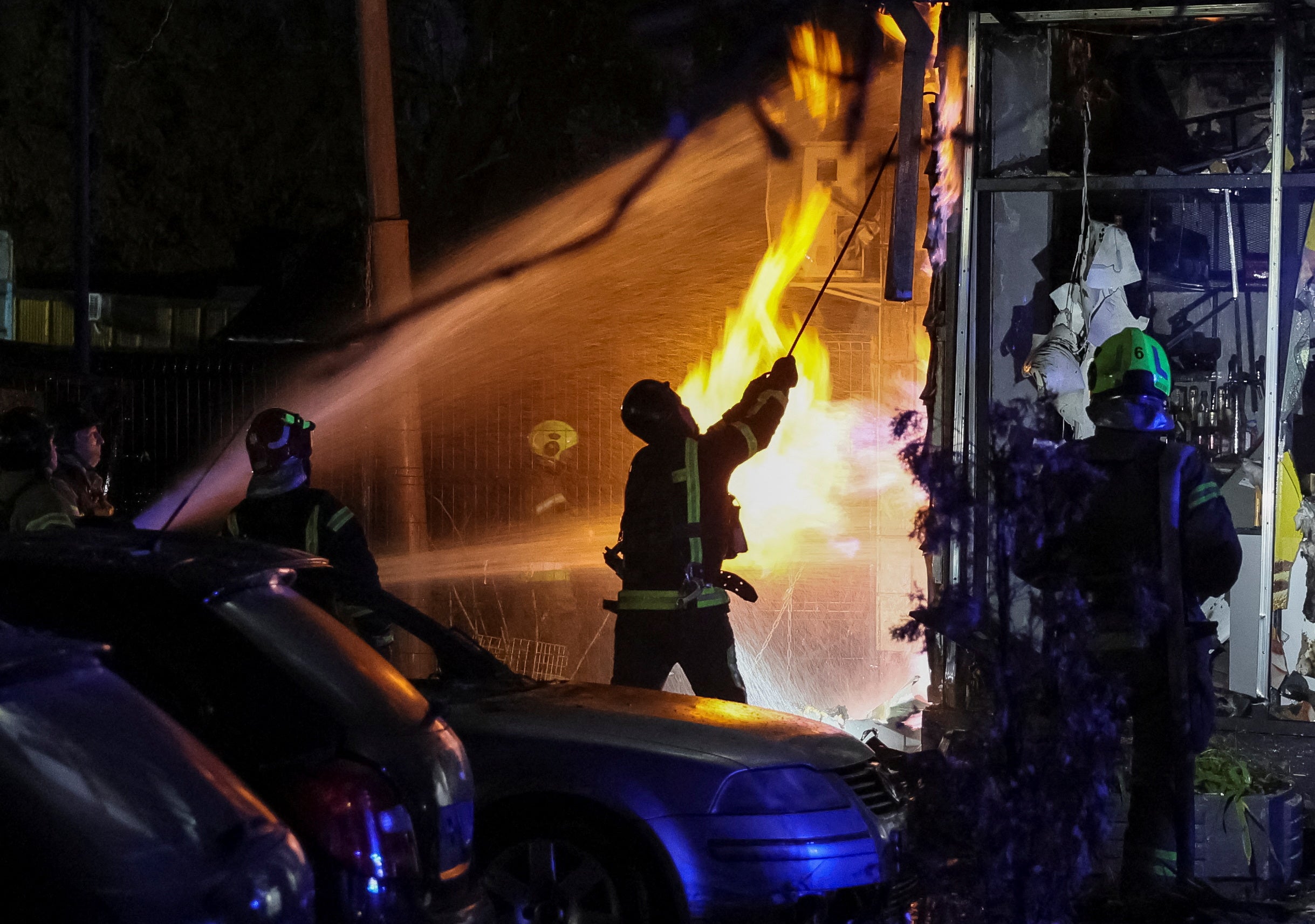 Firefighters work in an apartment building hit by a Russian drone strike, amid Russia's offensive on Ukraine in Kiev