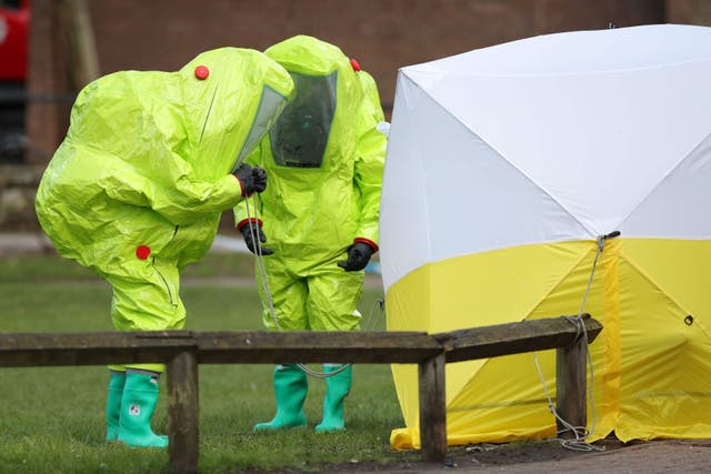 Personnel in hazmat suits work to secure a tent covering a bench in the Maltings shopping centre in Salisbury, where former Russian double agent Sergei Skripal and his daughter Yulia were found critically ill (Andrew Matthews/PA)