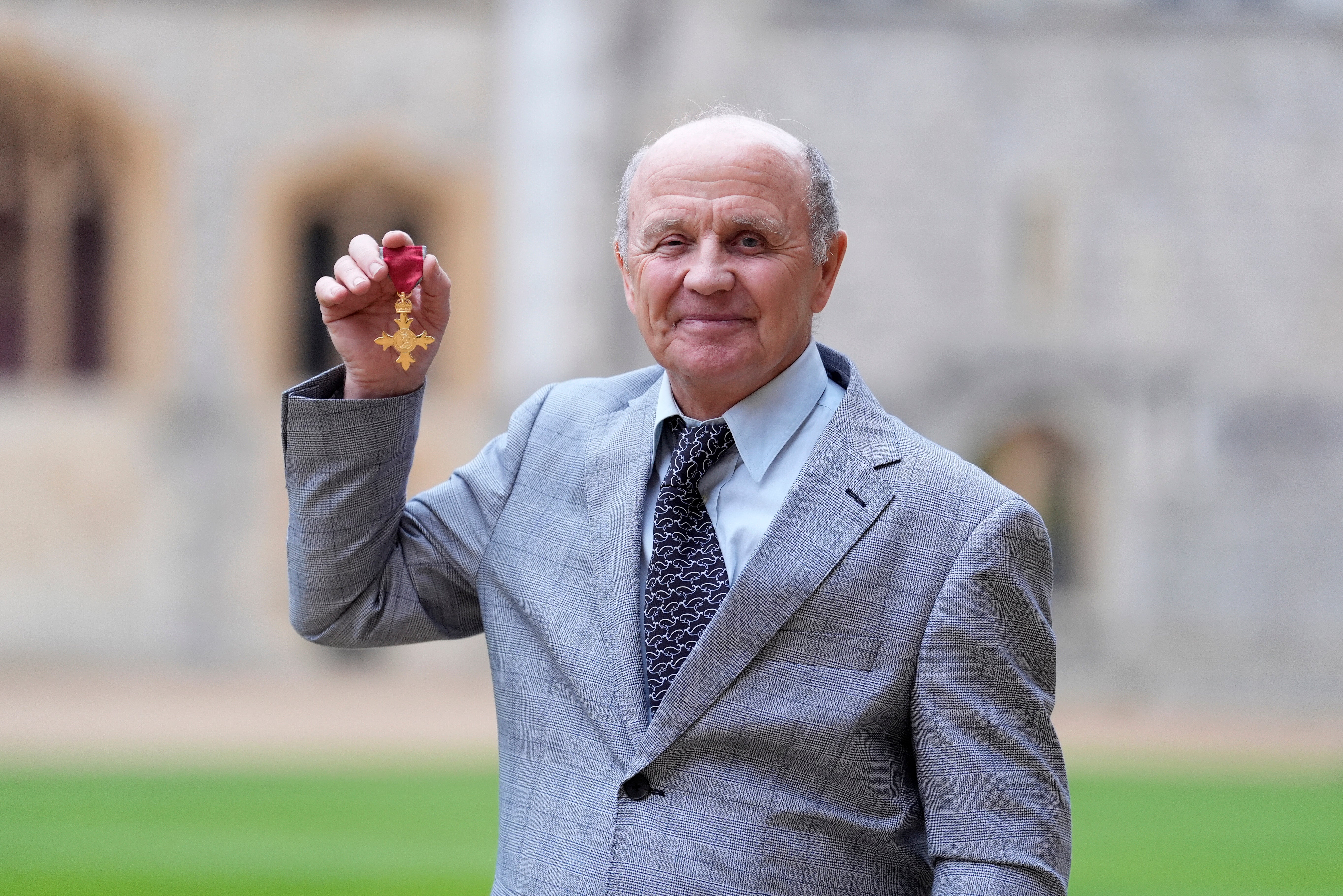 Cameraman and Marine Conservationist Douglas Allan poses after being made an Officer of the Order of the British Empire (OBE) by the Princess Royal