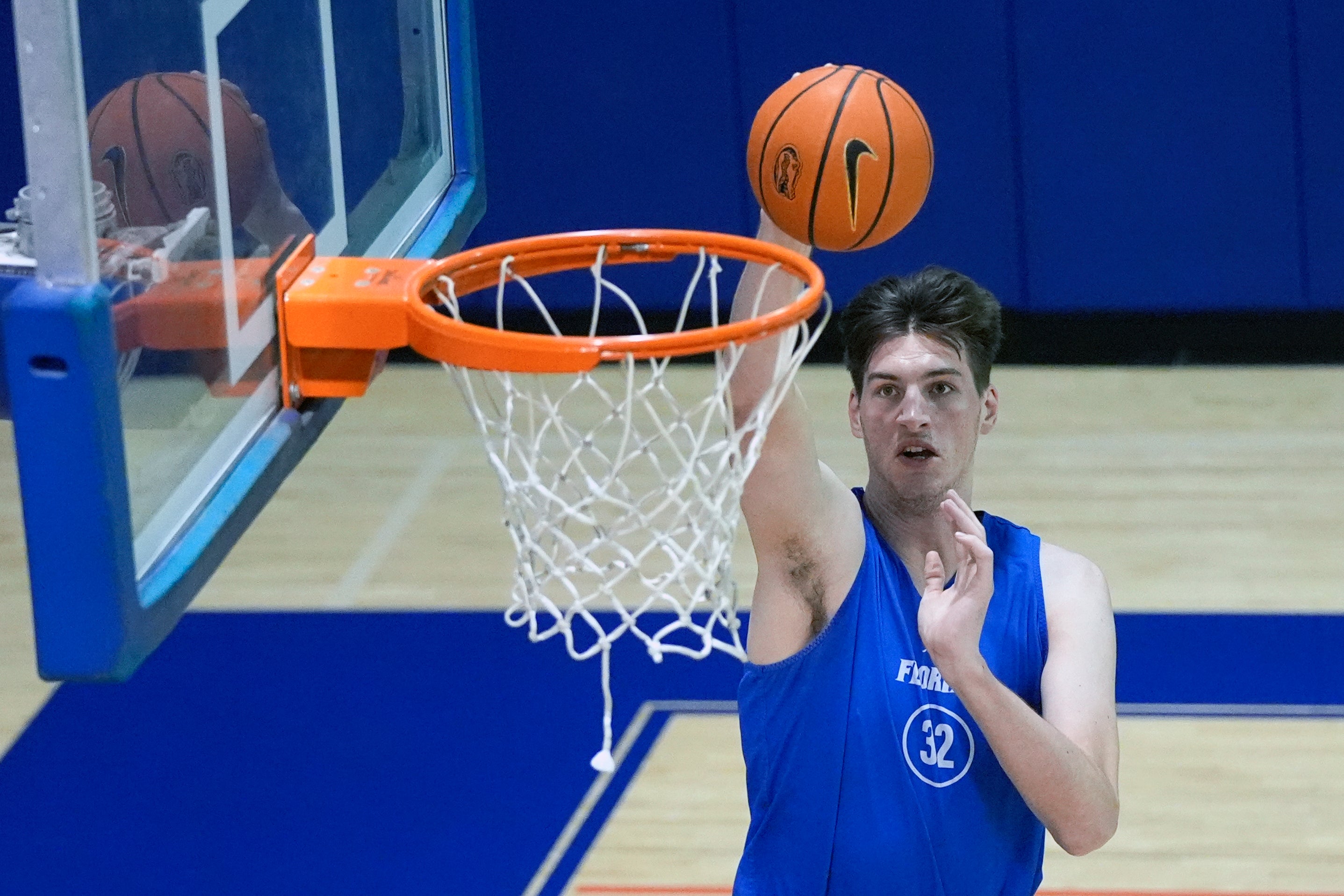 Olivier Rioux, a 7-foot-9 NCAA college basketball player at Florida, dunks the ball