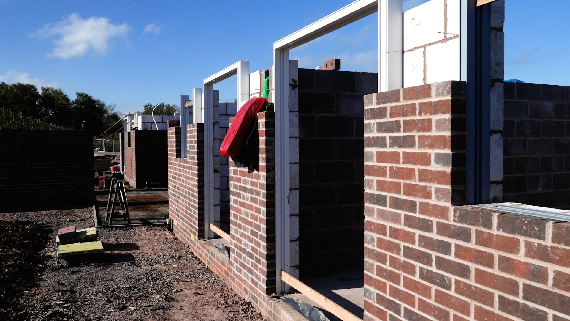 The new building’s outer walls can be seen reaching above head height as construction work continues