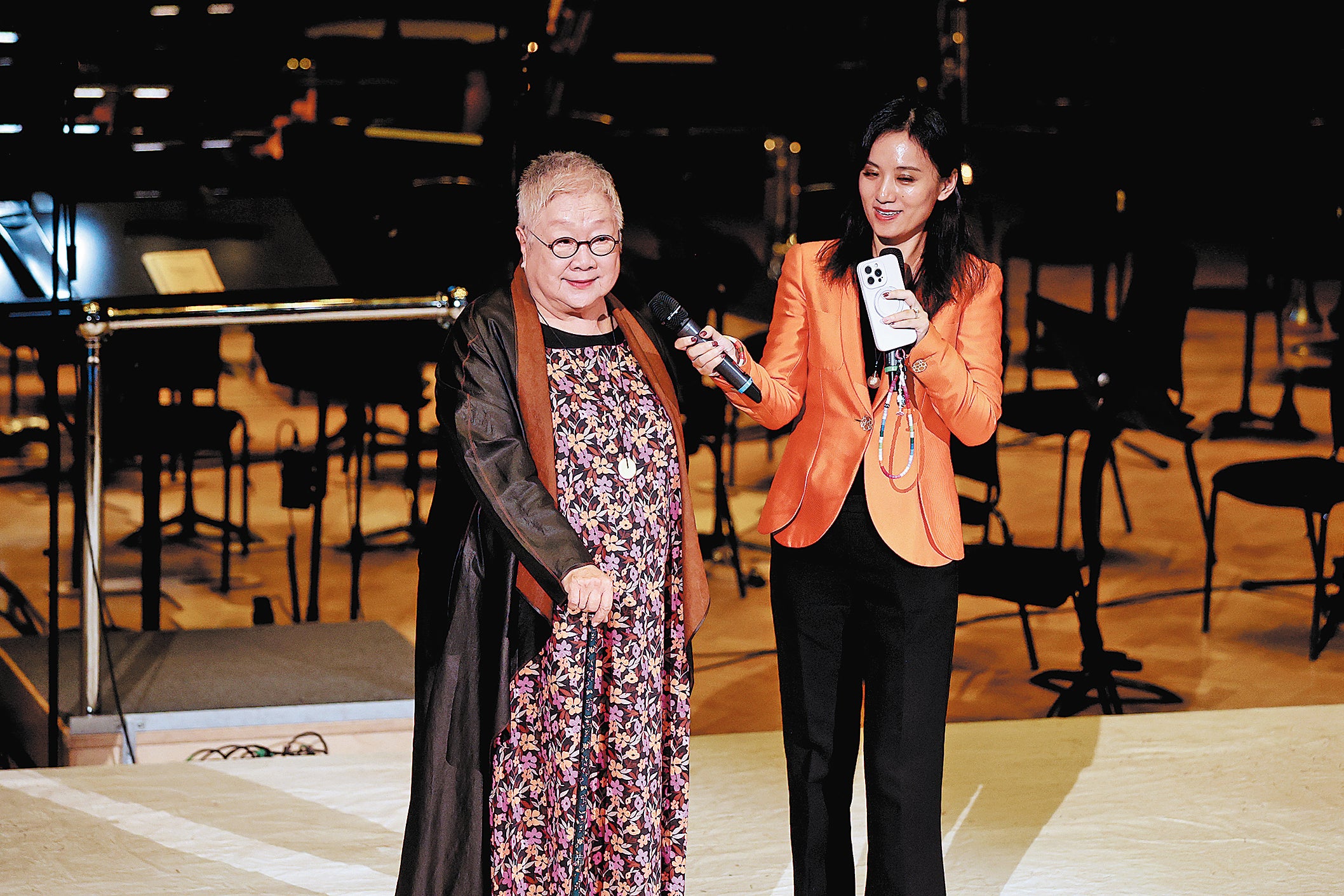 Chen Xinyi (left), 86, scriptwriter and director of the drama speaks before the performance