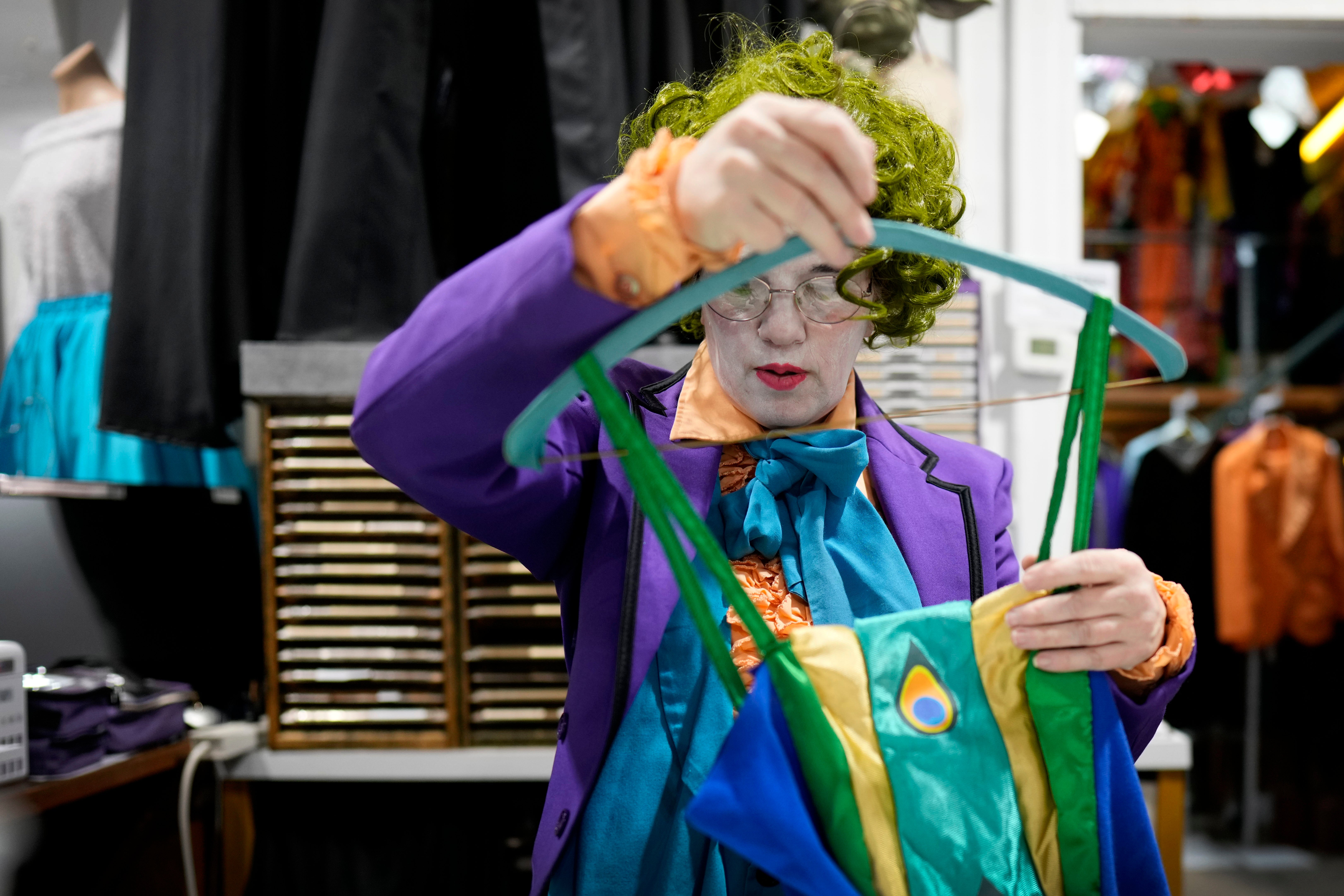 Michelle Nielsen prepares a costume for display at The Theatrical Shop, Tuesday, Oct. 29, 2024, in West Des Moines