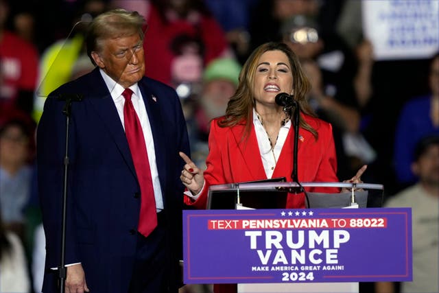 <p>Former President Donald Trump listens as Puerto Rico’s shadow US senator, Zoraida Buxo, speaks at a campaign rally in Allentown, on October 29, 2024</p>