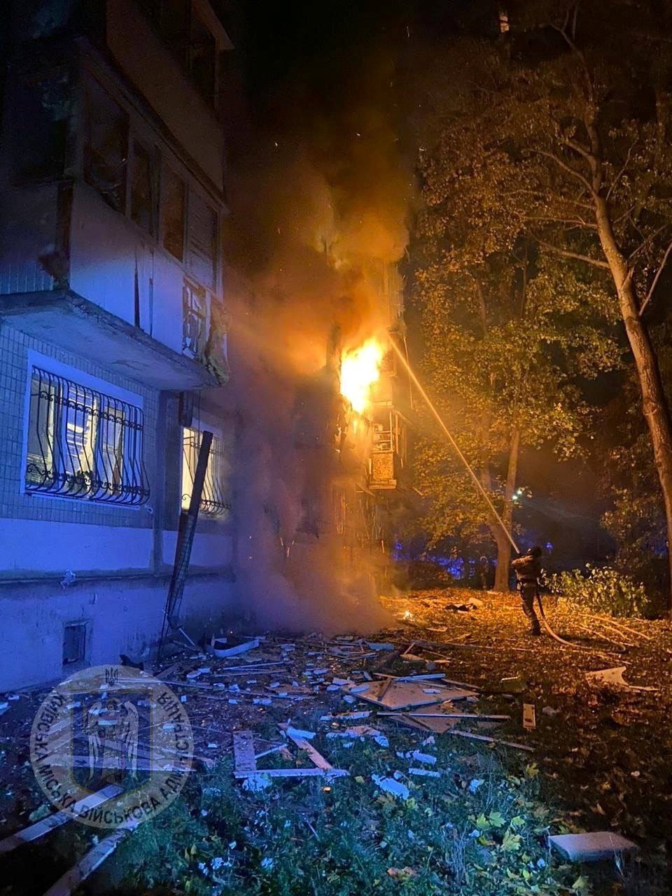 A firefighter works at a site of an apartment building hit by a Russian drone strike in the Ukrainian capital