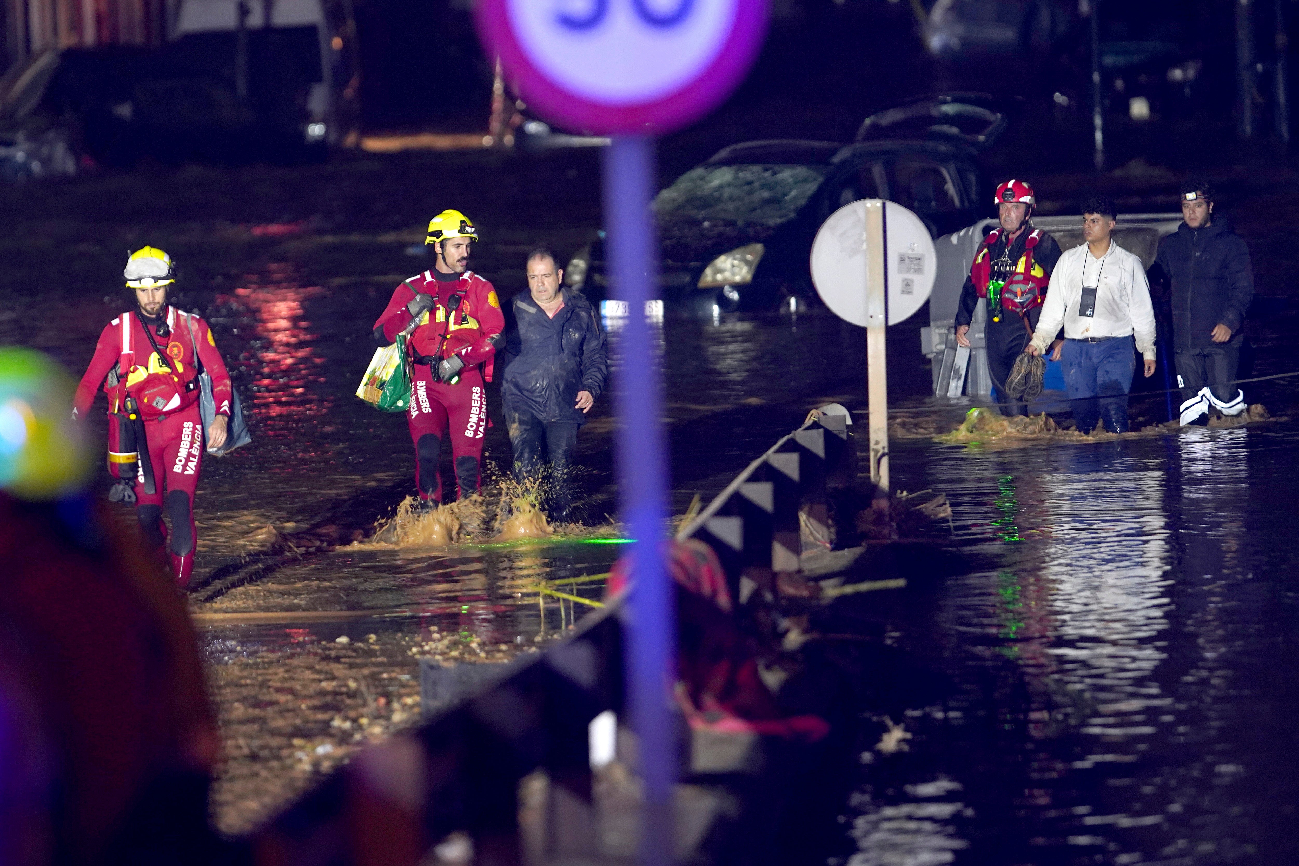 Emergency crew rescue residents after they were trapped in their homes following the flooding in Valencia