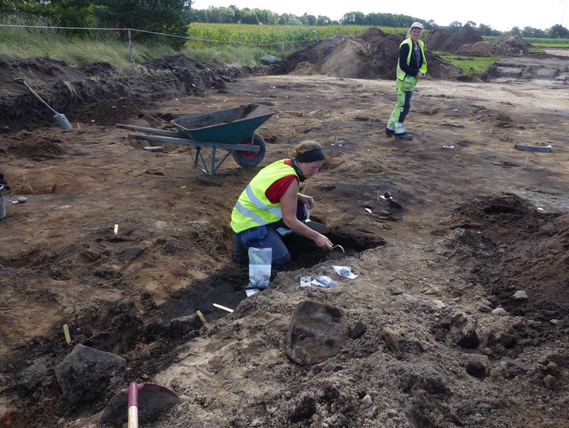 Archeologist Petra Nordin examines one of the graves