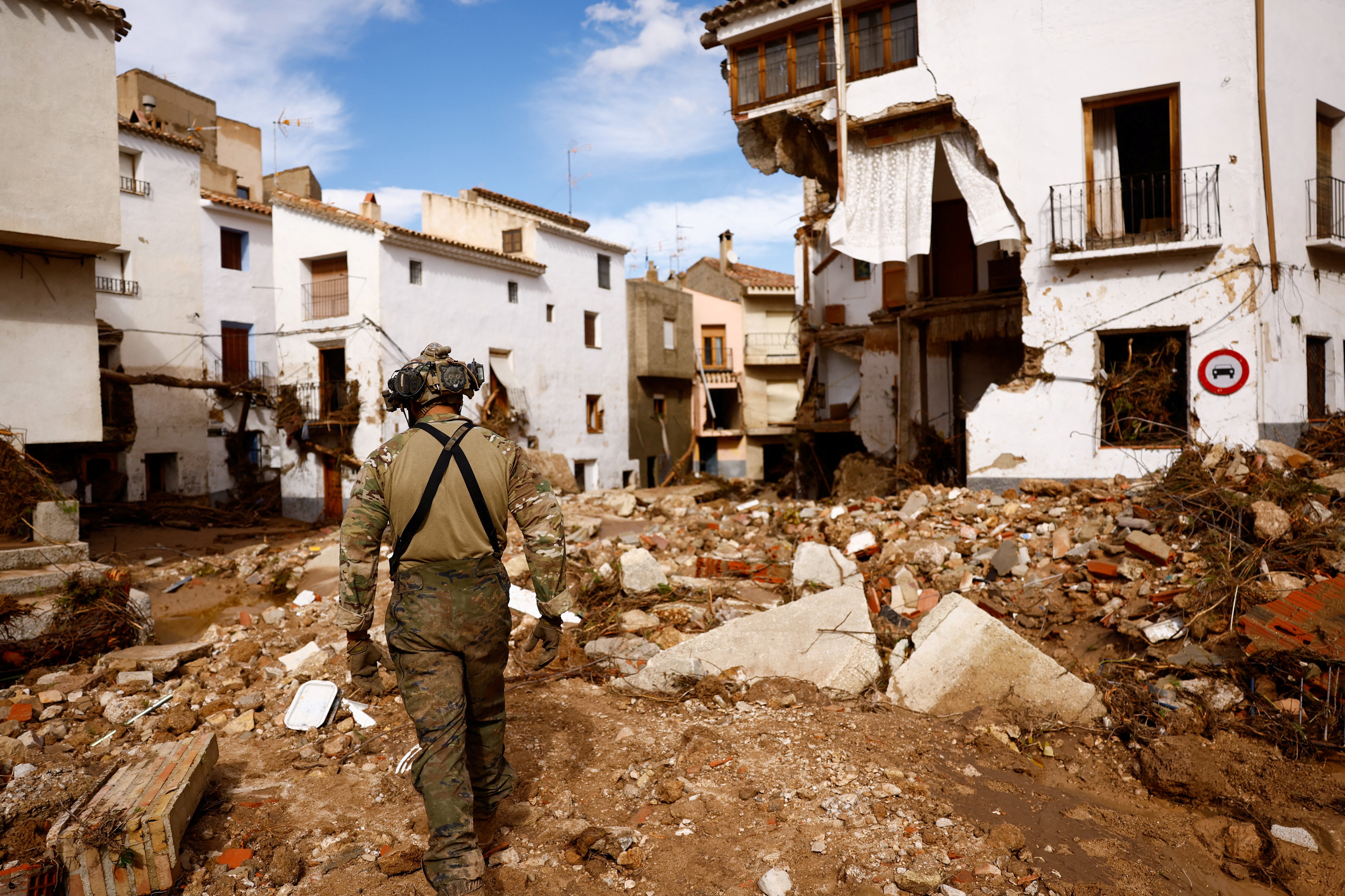 A member of Spain's UME military unit walks over the rubble in Letur after heavy rains caused flooding