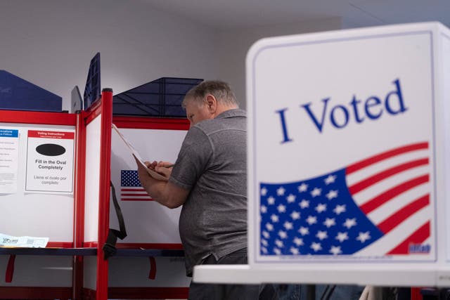 <p>Voters fill in their ballots at a polling place in Virginia on  September 20. </p>