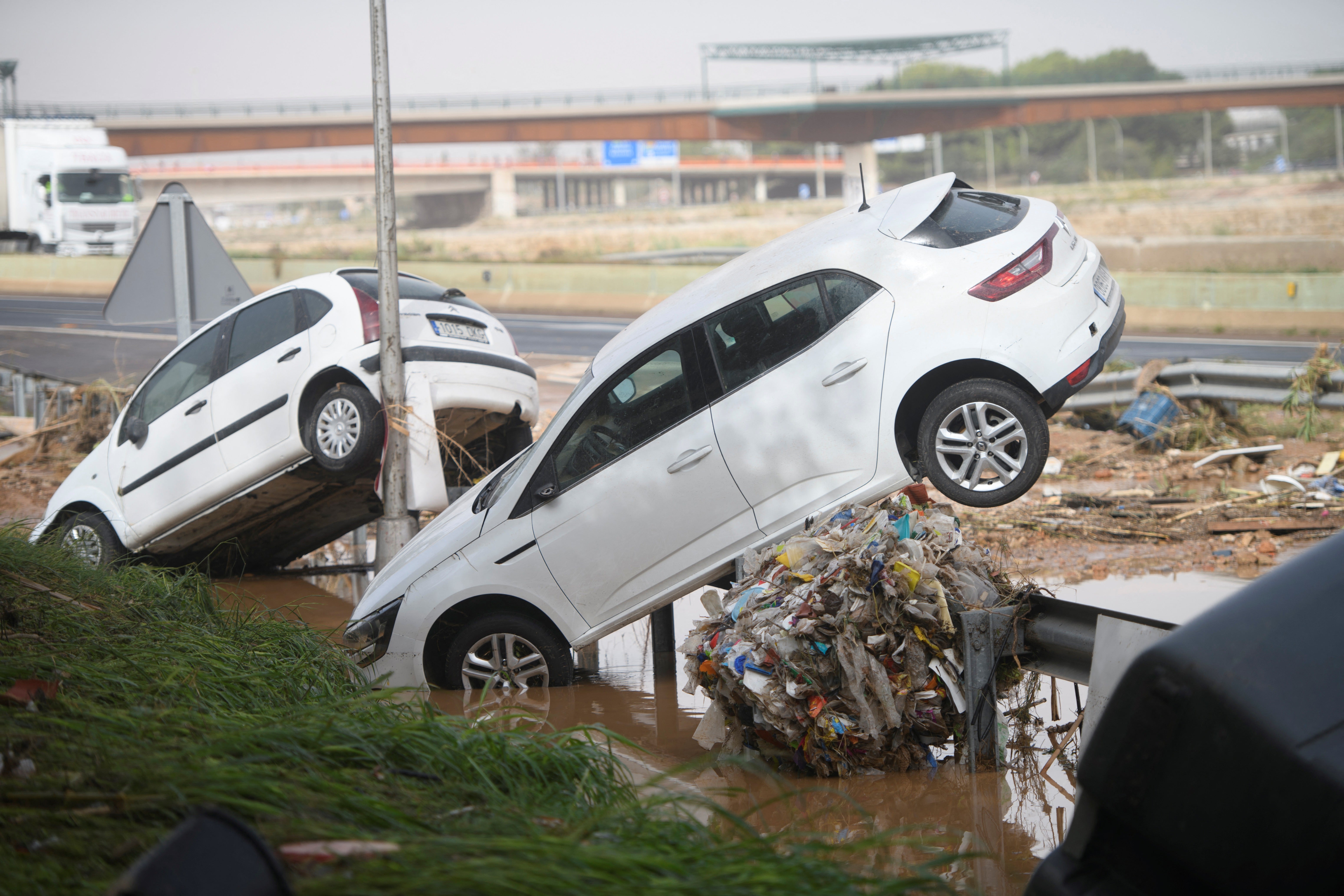 Cars stand on the barriers on the side of the road in Valencia