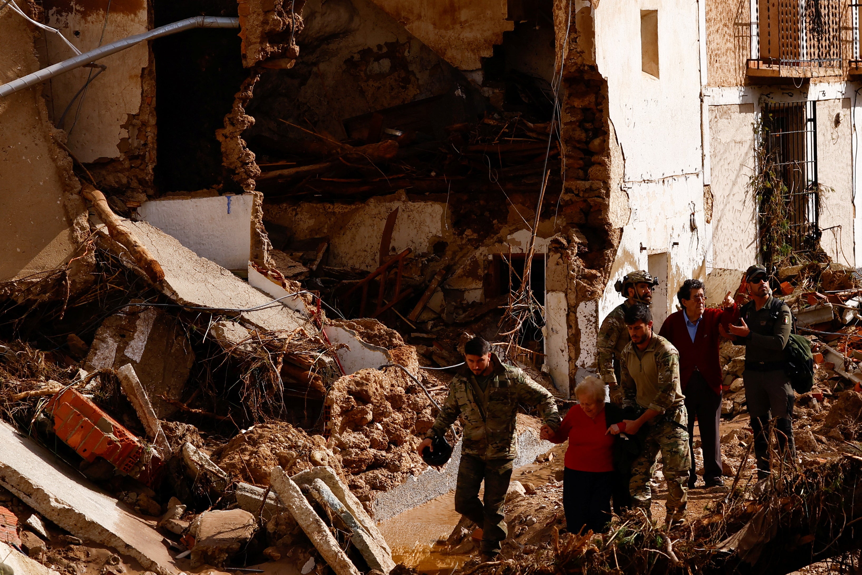 Encarna Rivero, 88, and her husband Jose Tomas, 89, are rescued after becoming stranded in a neighbor's house