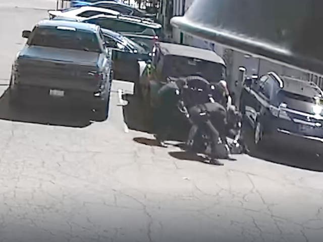 <p>Phoenix police officers hold down Michael Kenyon during an encounter in Phoenix, Arizona. The temperature was 114 degrees Fahrenheit and Kenyon suffered numerous third degree burns to his body from the hot asphalt</p>