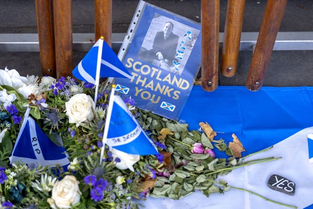 Tributes to Alex Salmond have been left outside the Scottish Parliament building (Jane Barlow/PA)