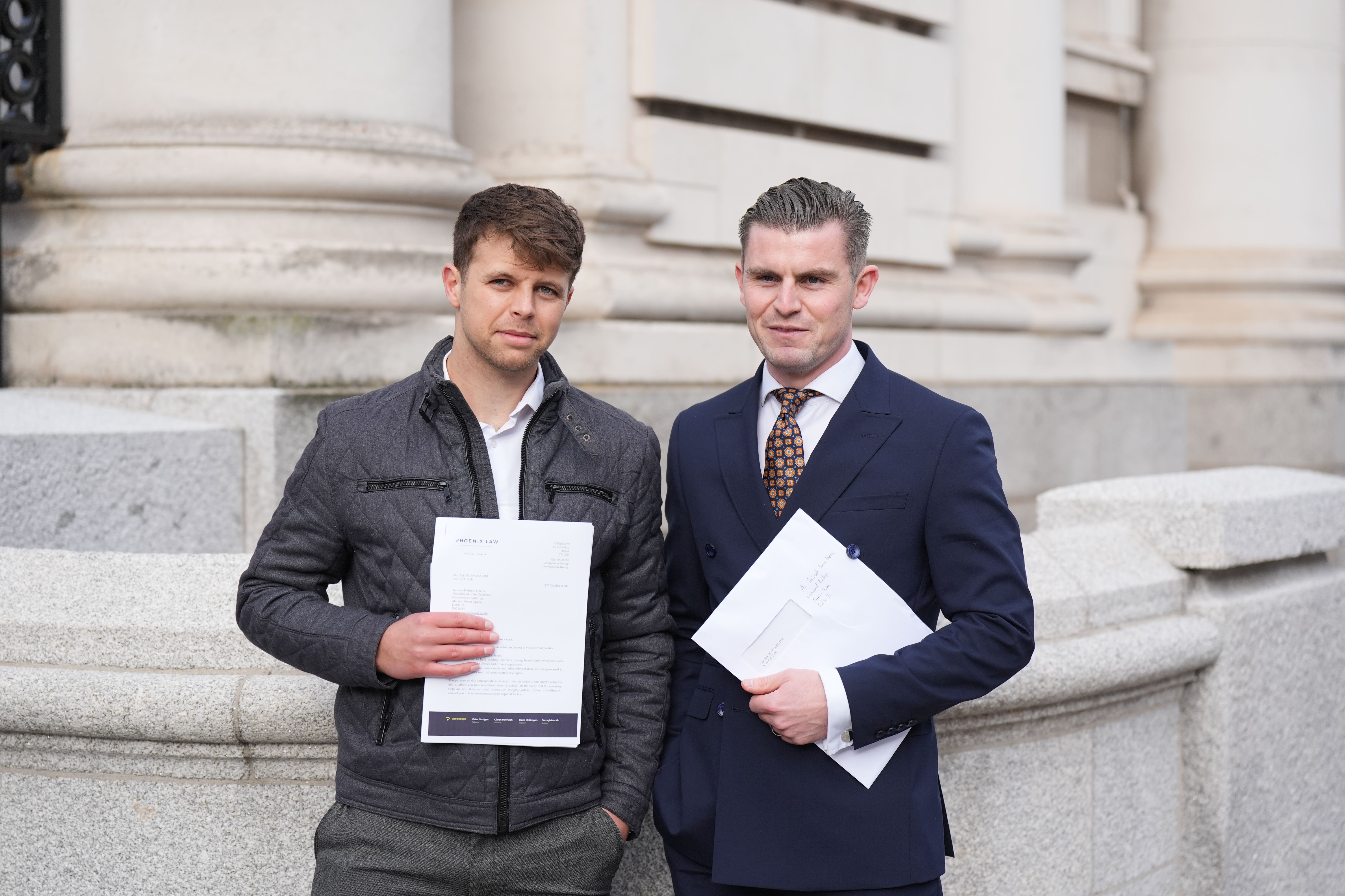 Brian Cuthbert (left), deputy director of Uplift and solicitor Darragh Mackin outside Government Buildings in Dublin (Niall Carson/PA)