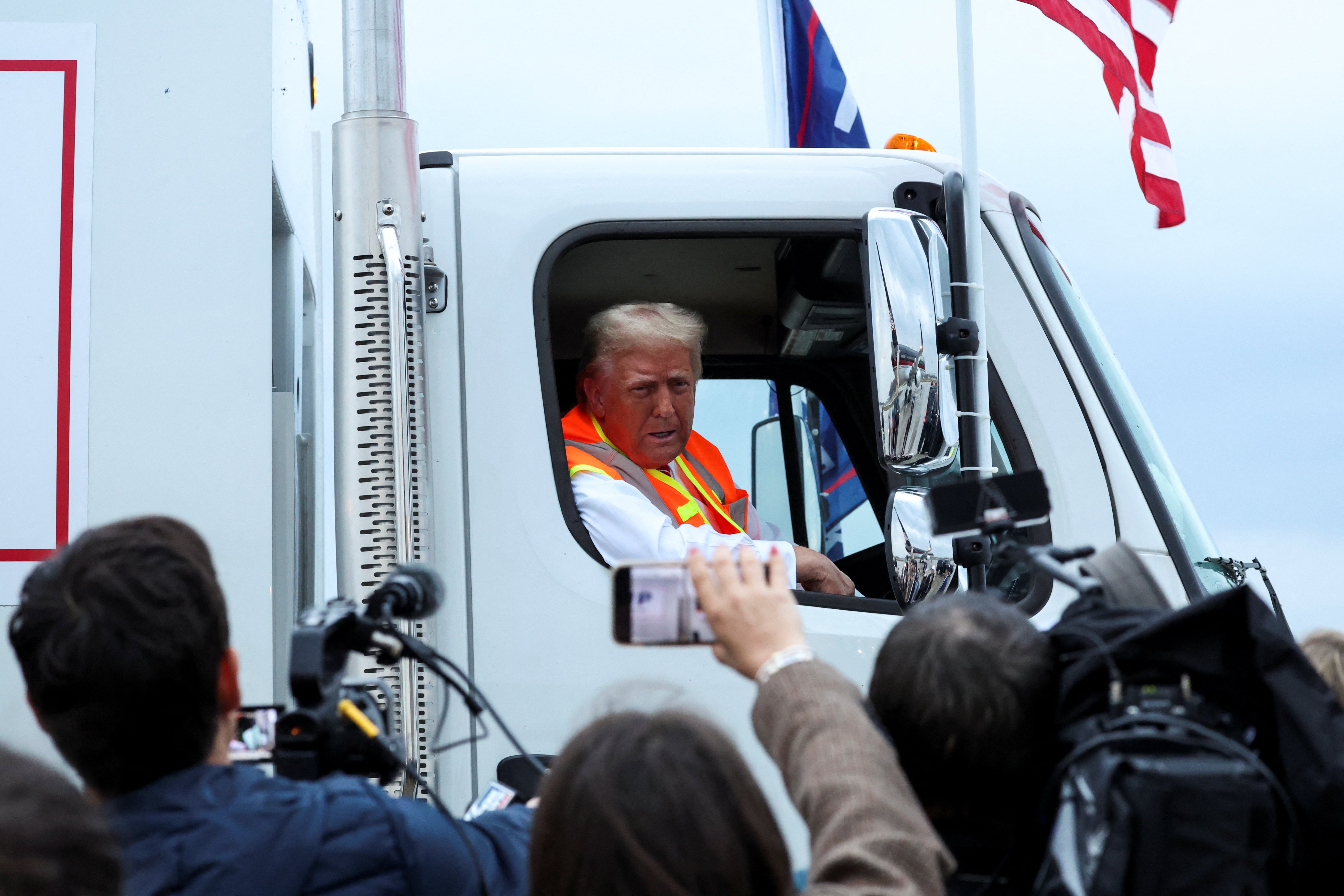 Trump speaks to the members of the media from a garbage truck in Green Bay, Wisconsin, days before the 2024 election