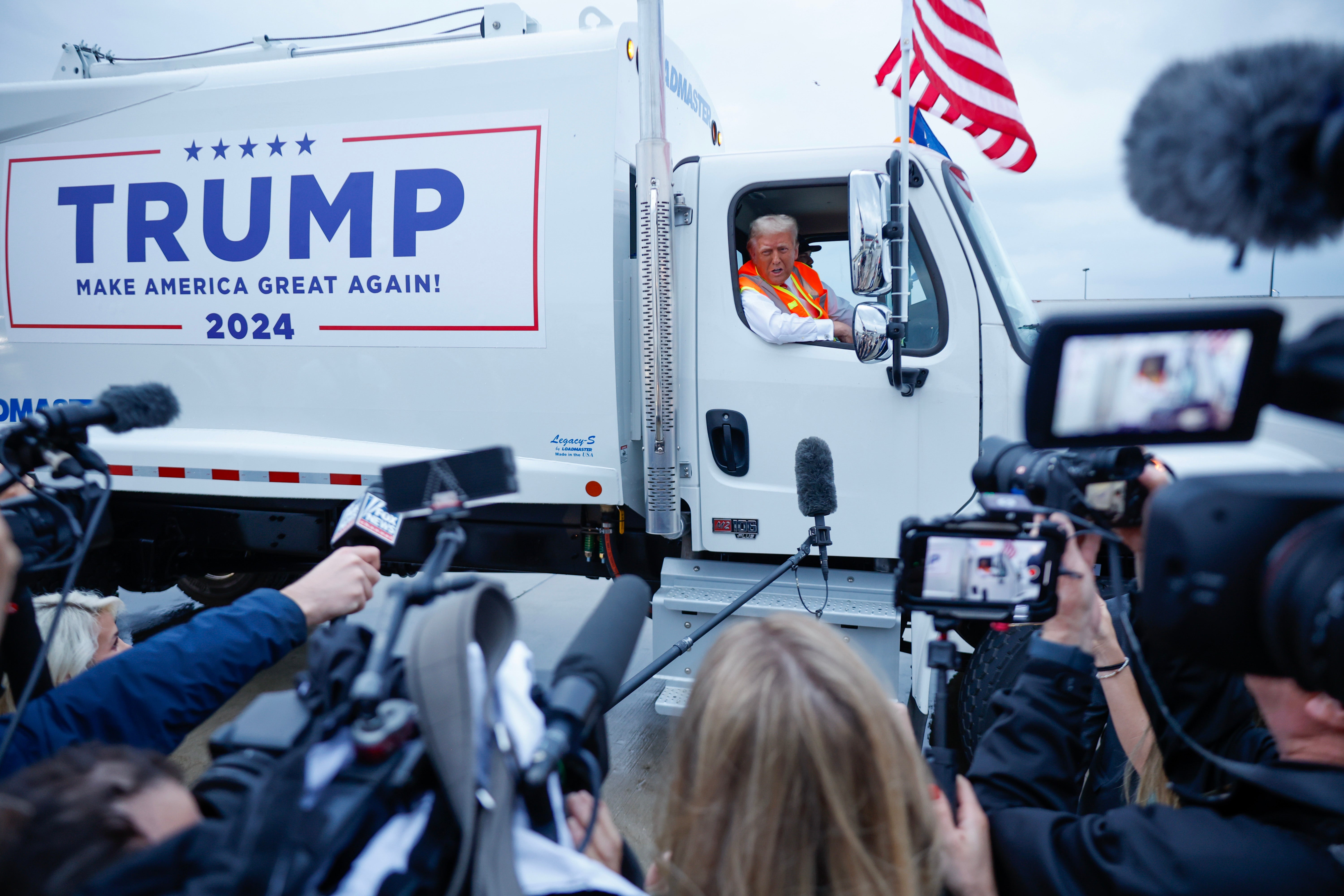 Republican presidential nominee, former President Donald Trump holds a press conference from inside trash hauler at Green Bay Austin Straubel International Airport on October 30, 2024