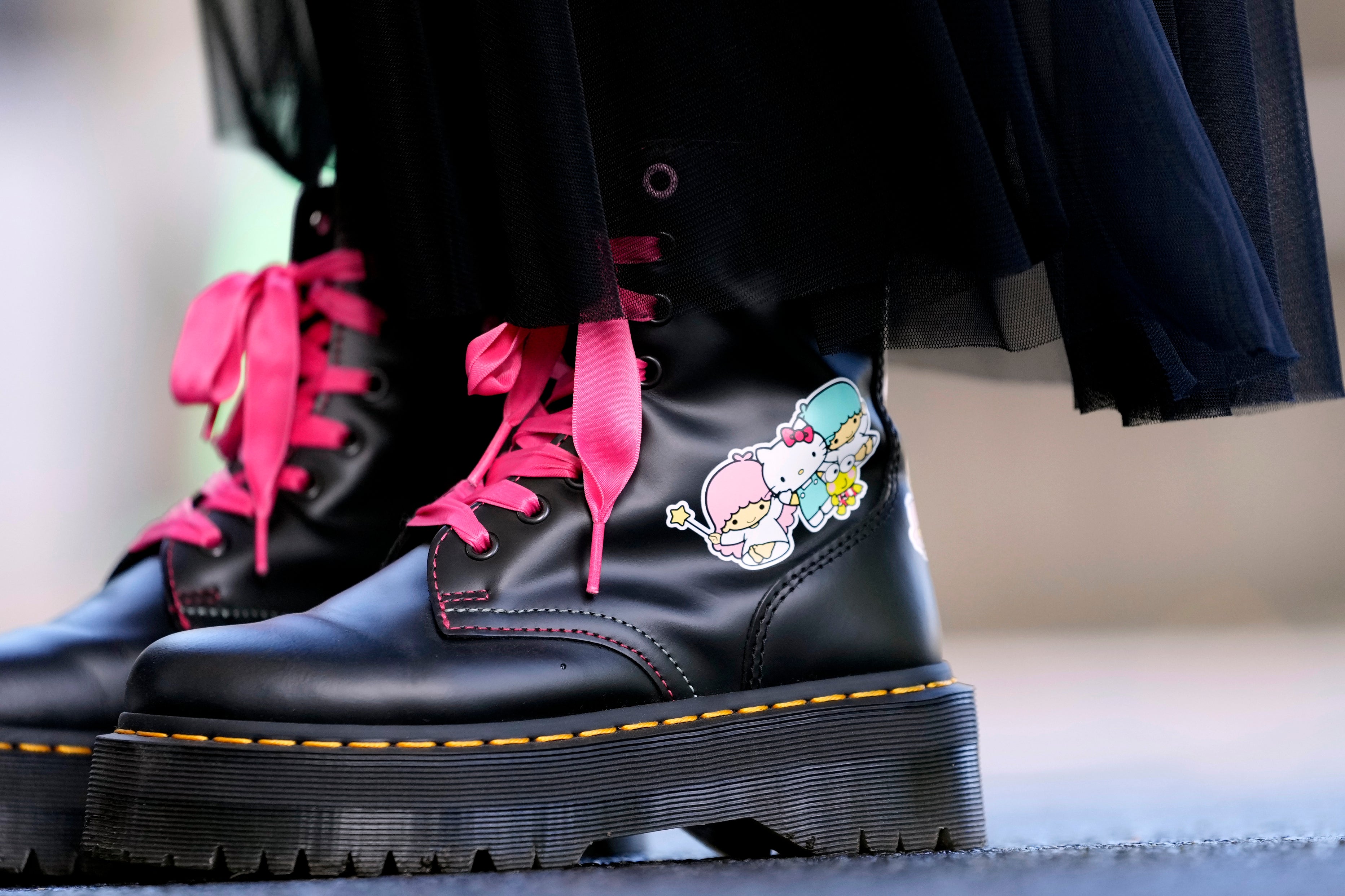 A visitor wears boots featuring Hello Kitty at the National Museum