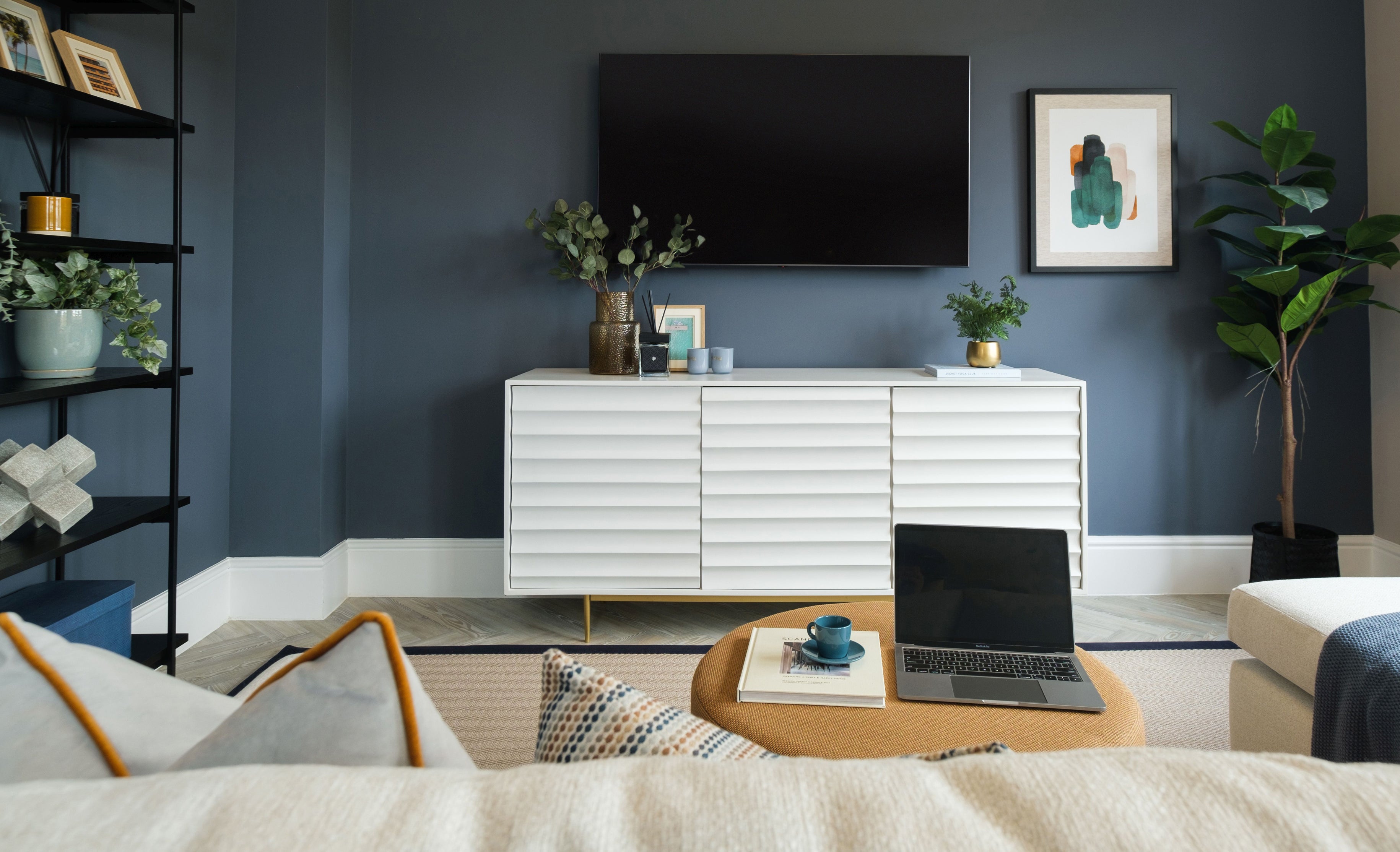 Living room with TV on wall and space saving storage