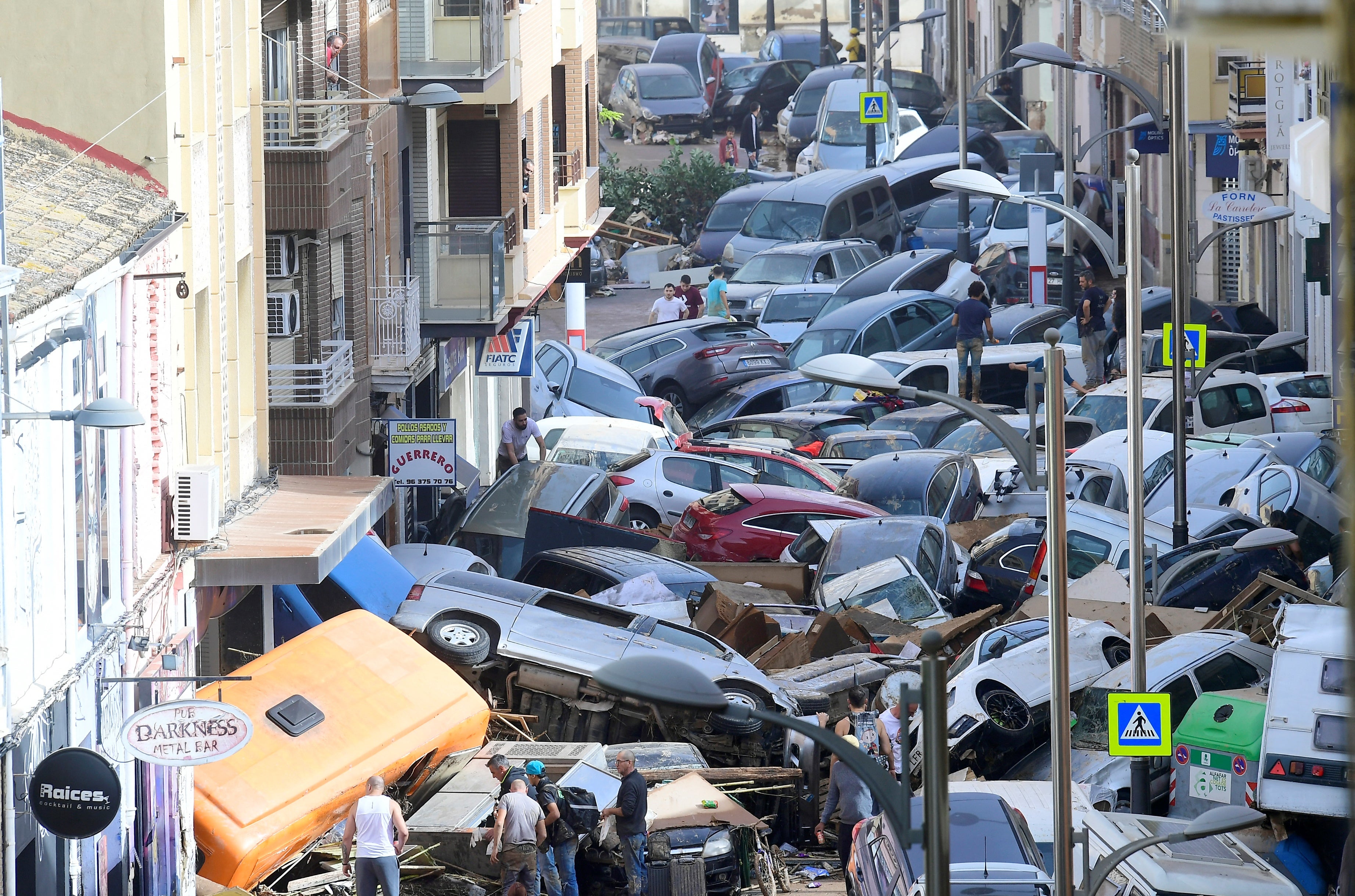 Floods left cars piled up on mud-filled streets