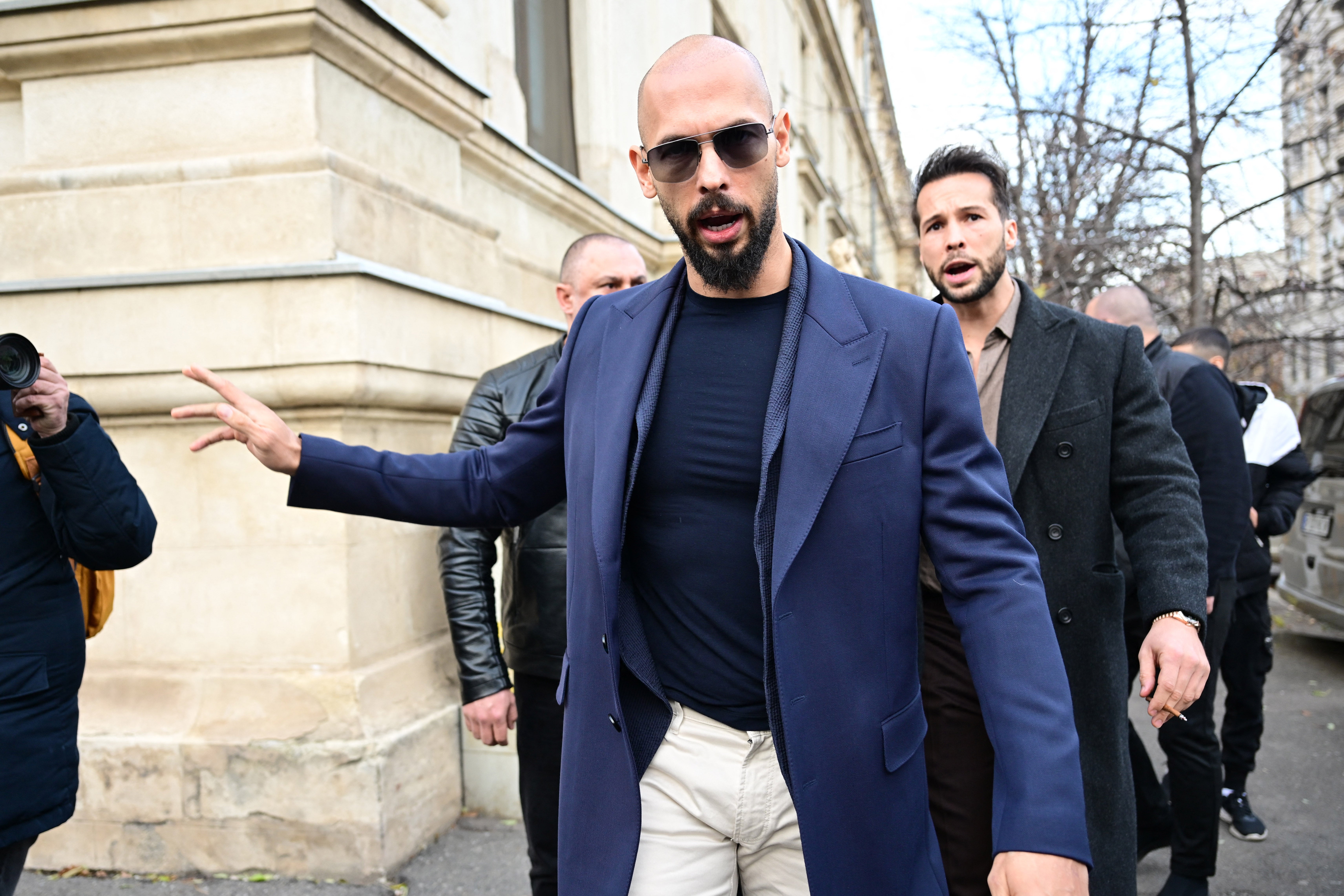 Andrew Tate (L) and Tristan Tate (R) walk from the Bucharest's Court of Appeal