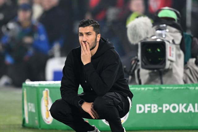 <p>Nuri Sahin watches on as his Borussia Dortmund side exit the DFB Cup</p>