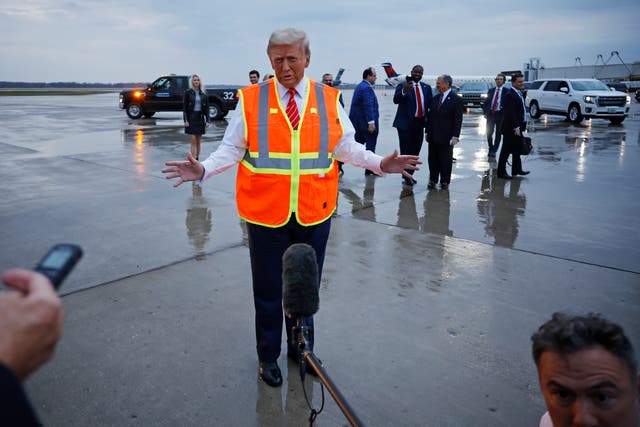 <p>Donald Trump speaks to reporters while wearing a safety vest on the tarmac at Green Bay Austin Straubel International Airport on October 30, 2024 in Green Bay, Wisconsin</p>