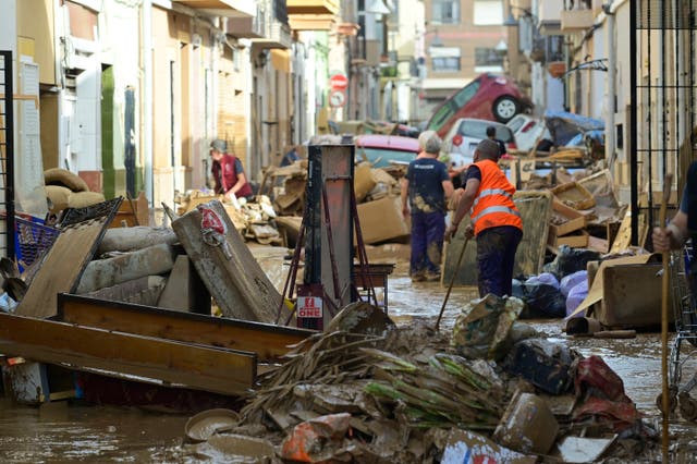 <p>Residents try to clean their houses as the street is covered in mud in the town of Alfafar in the region of Valencia, eastern Spain </p>