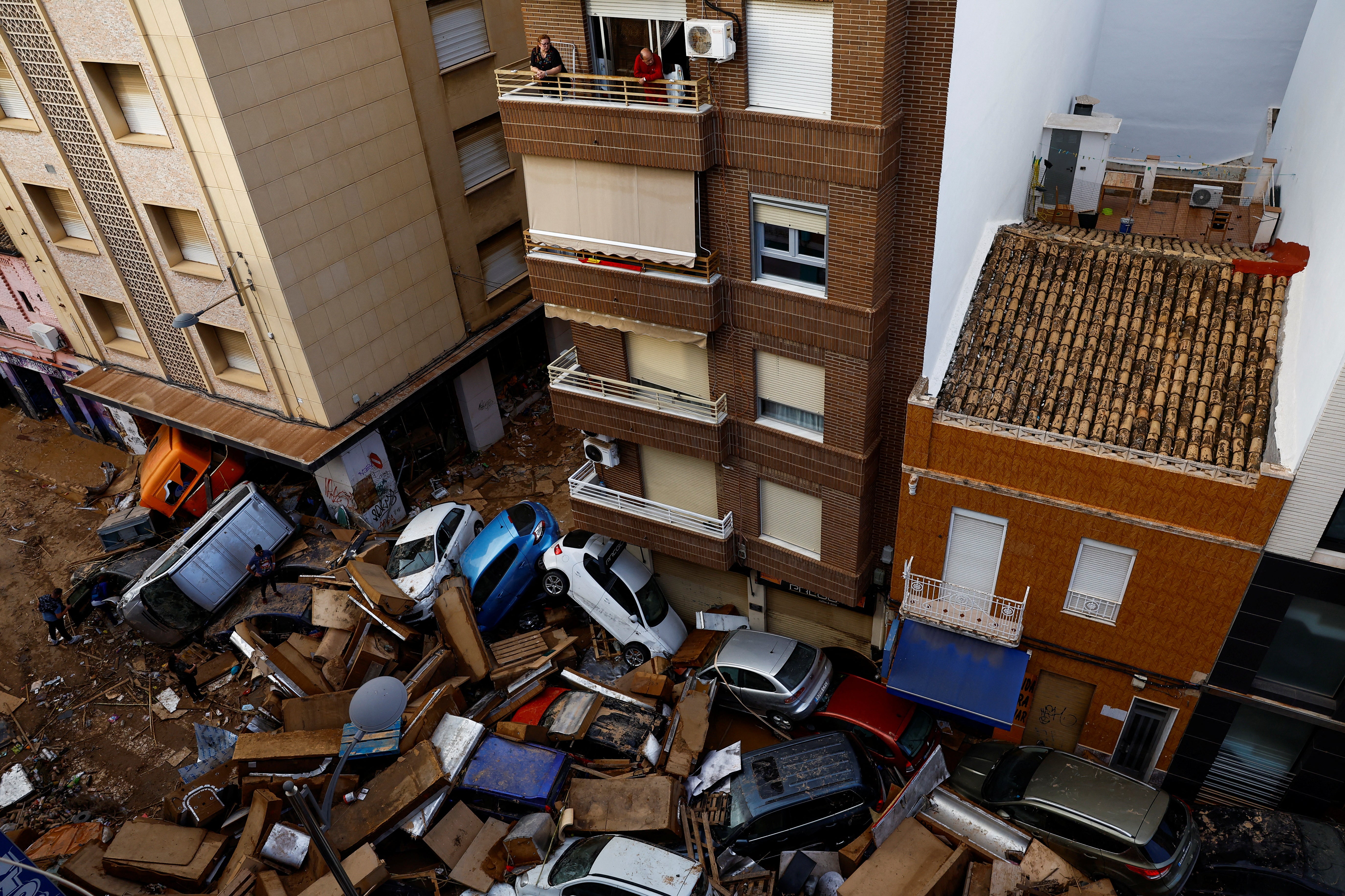 Cars are piled up on a street in La Torre neighbourhood in Sedavi, Valencia, Spain