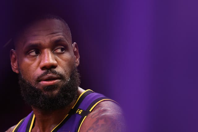 <p>LeBron James of the LA Lakers sits on the bench during the second half of their NBA game against the Phoenix Suns on October 28, 2024</p>