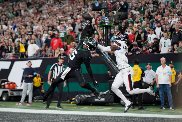 New York Jets wide receiver Garrett Wilson catches a pass for a touchdown as Houston Texans cornerback Kamari Lassiter defends (Seth Wenig/AP)