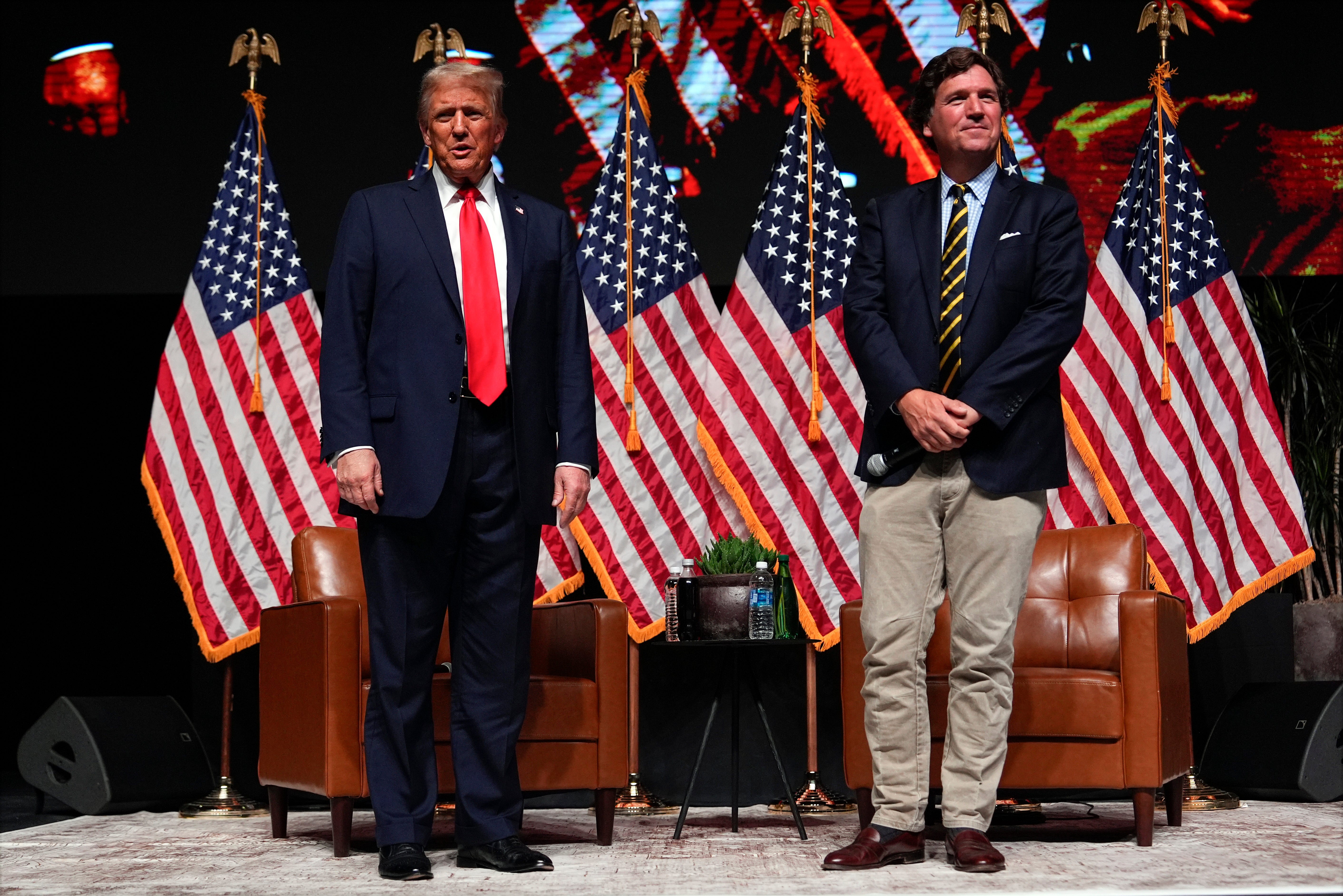 <p>Republican presidential nominee former President Donald Trump speaks with Tucker Carlson during a Tucker Carlson Live Tour show at Desert Diamond Arena, Thursday, Oct. 31, 2024, in Glendale, Arizona</p>