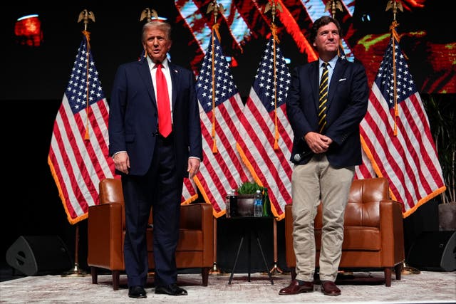 <p>Republican presidential nominee former President Donald Trump speaks with Tucker Carlson during a Tucker Carlson Live Tour show at Desert Diamond Arena, Thursday, Oct. 31, 2024, in Glendale, Arizona</p>