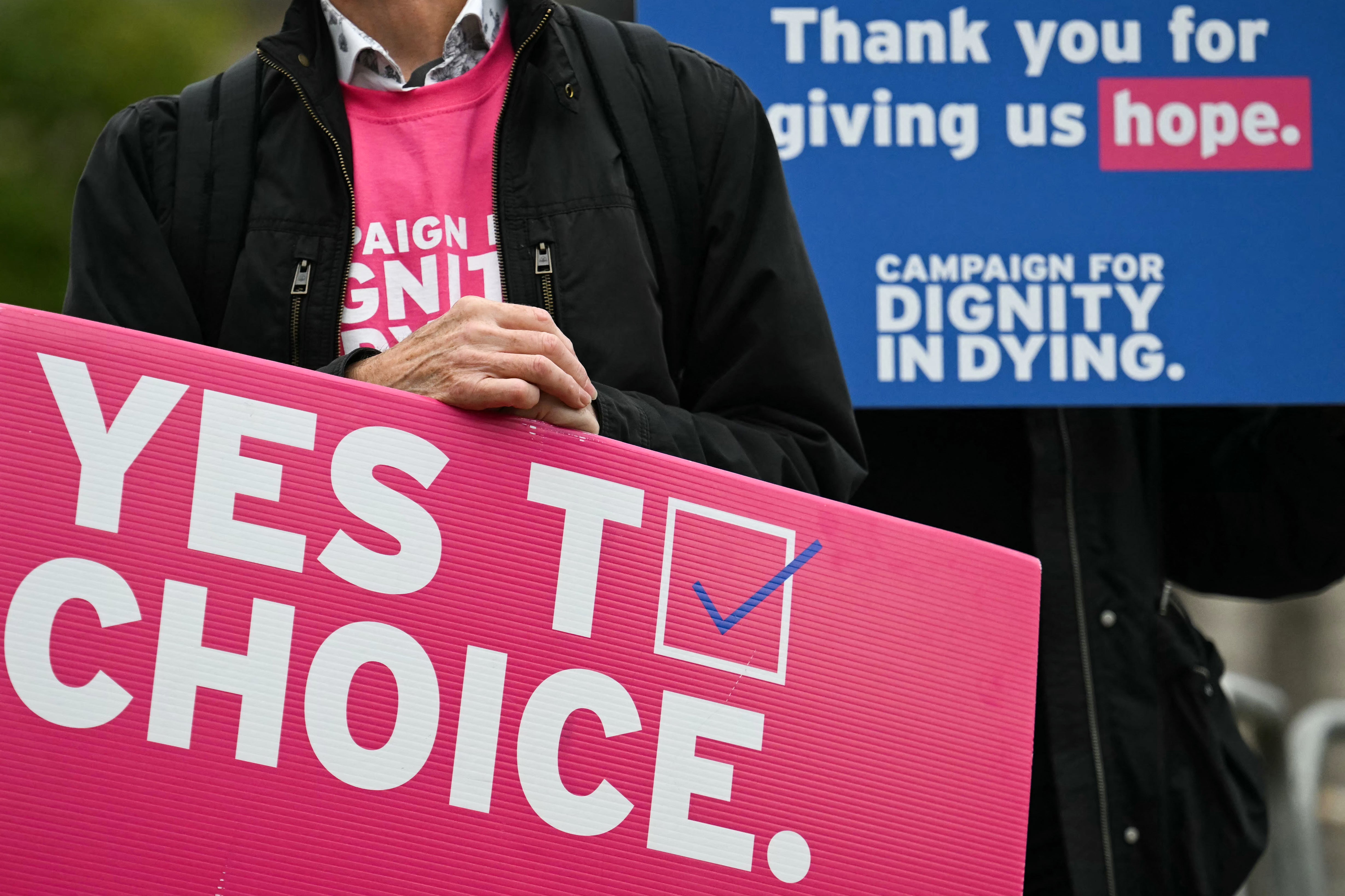 Politics tamfitronics A campaigner from ‘Dignity in Dying' hold a placard during a demonstration outside Westminster