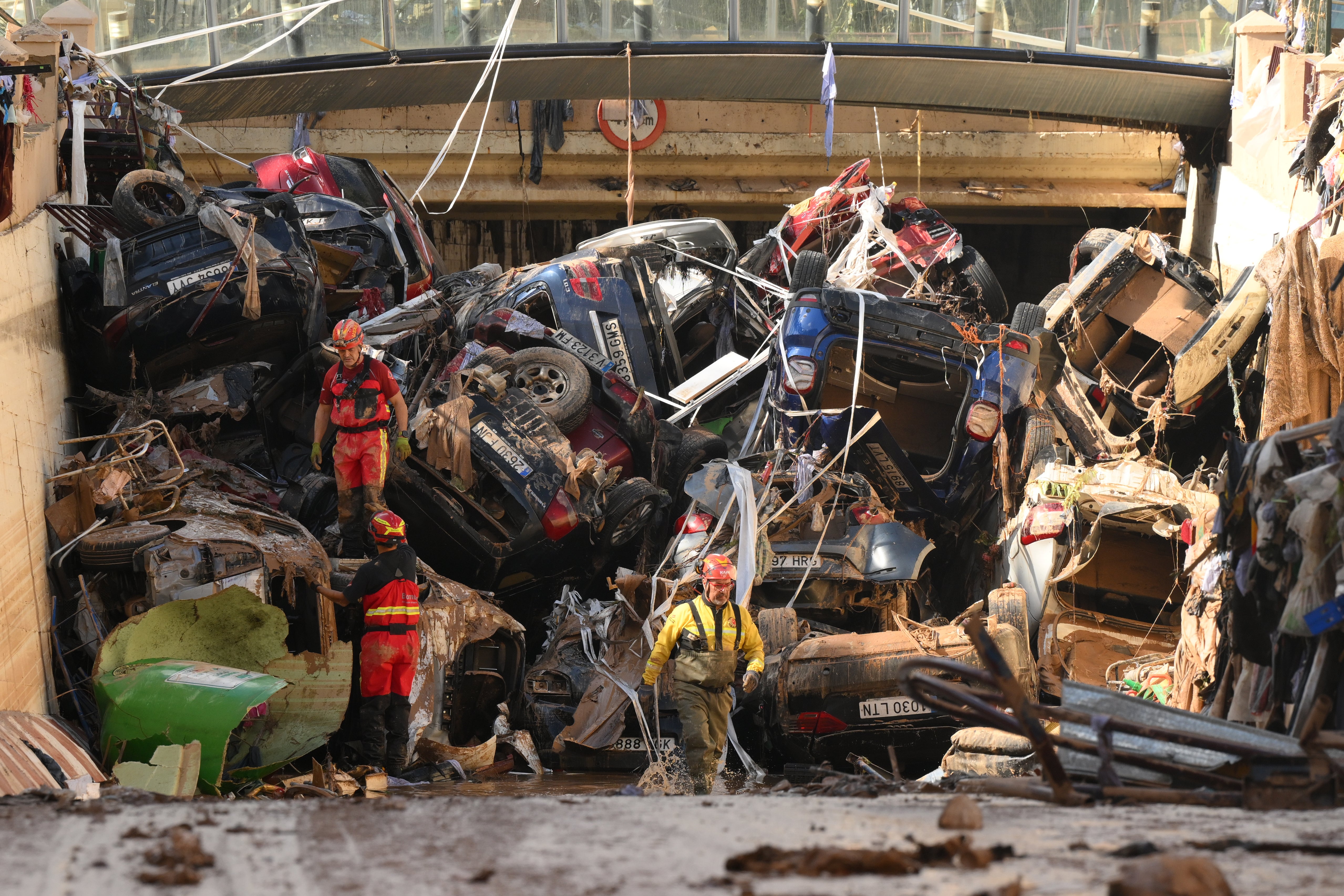 <p>Members of the fire brigade search cars after devastating floods in Valencia, Spain.  </p>