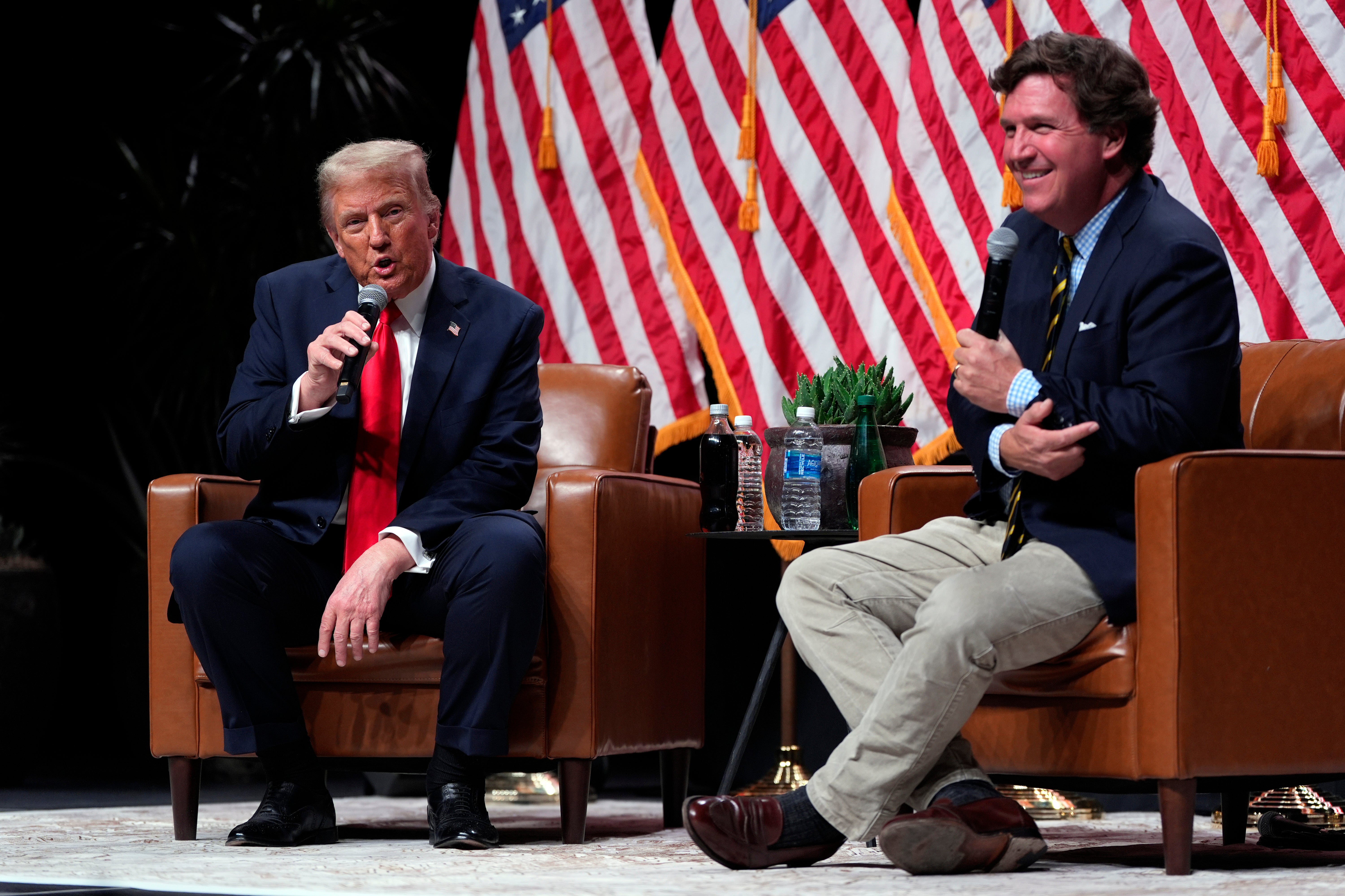 Tucker Carlson and Donald Trump at a campaign stop in Glendale, Arizona