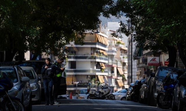 <p>Athens Police officers guard near the entrance of a building following an explosion Apartment Blast</p>