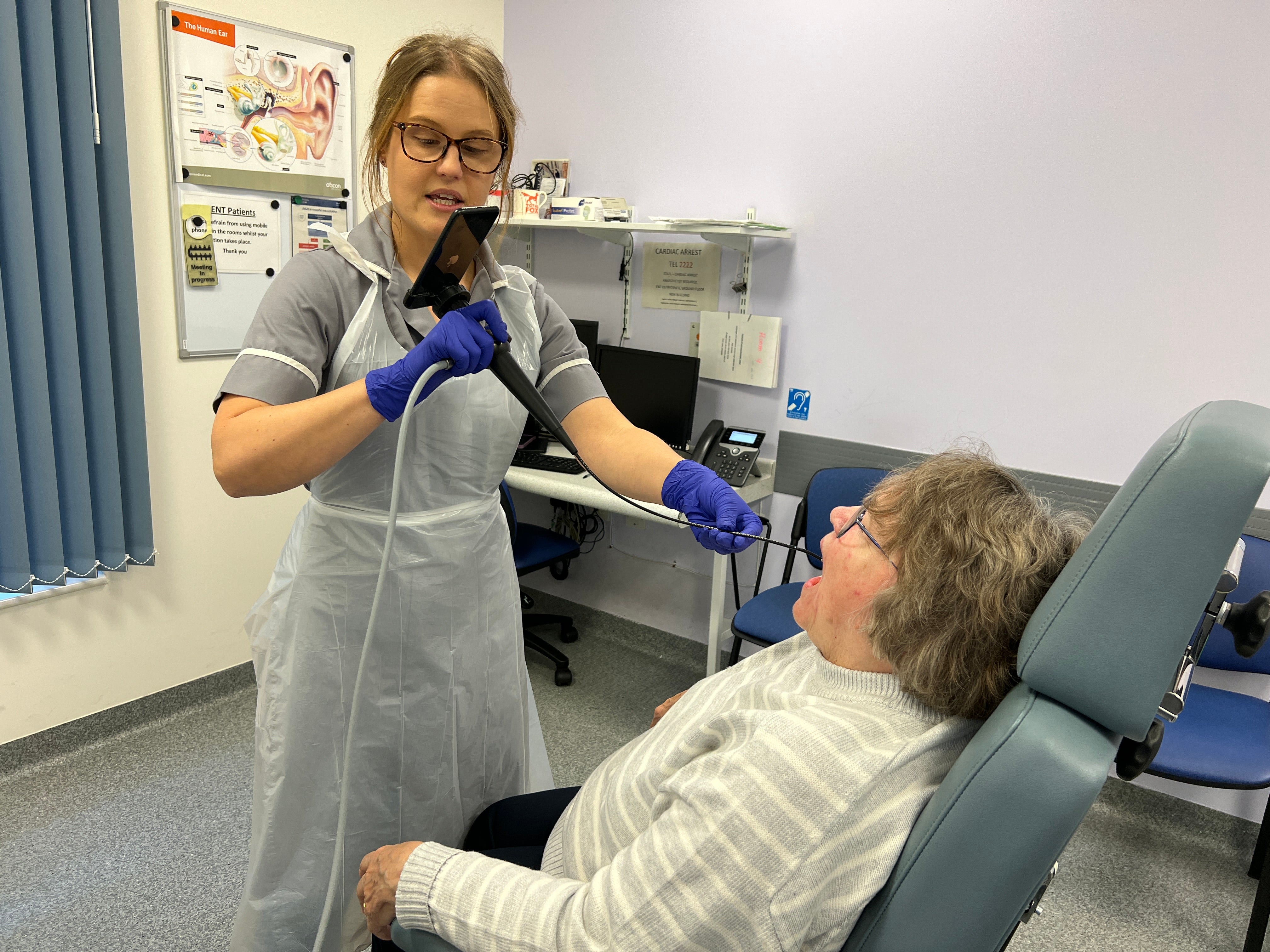 Clinician Nina Glazzard uses an endoscope-I adapter on Janet Hennessy, 76