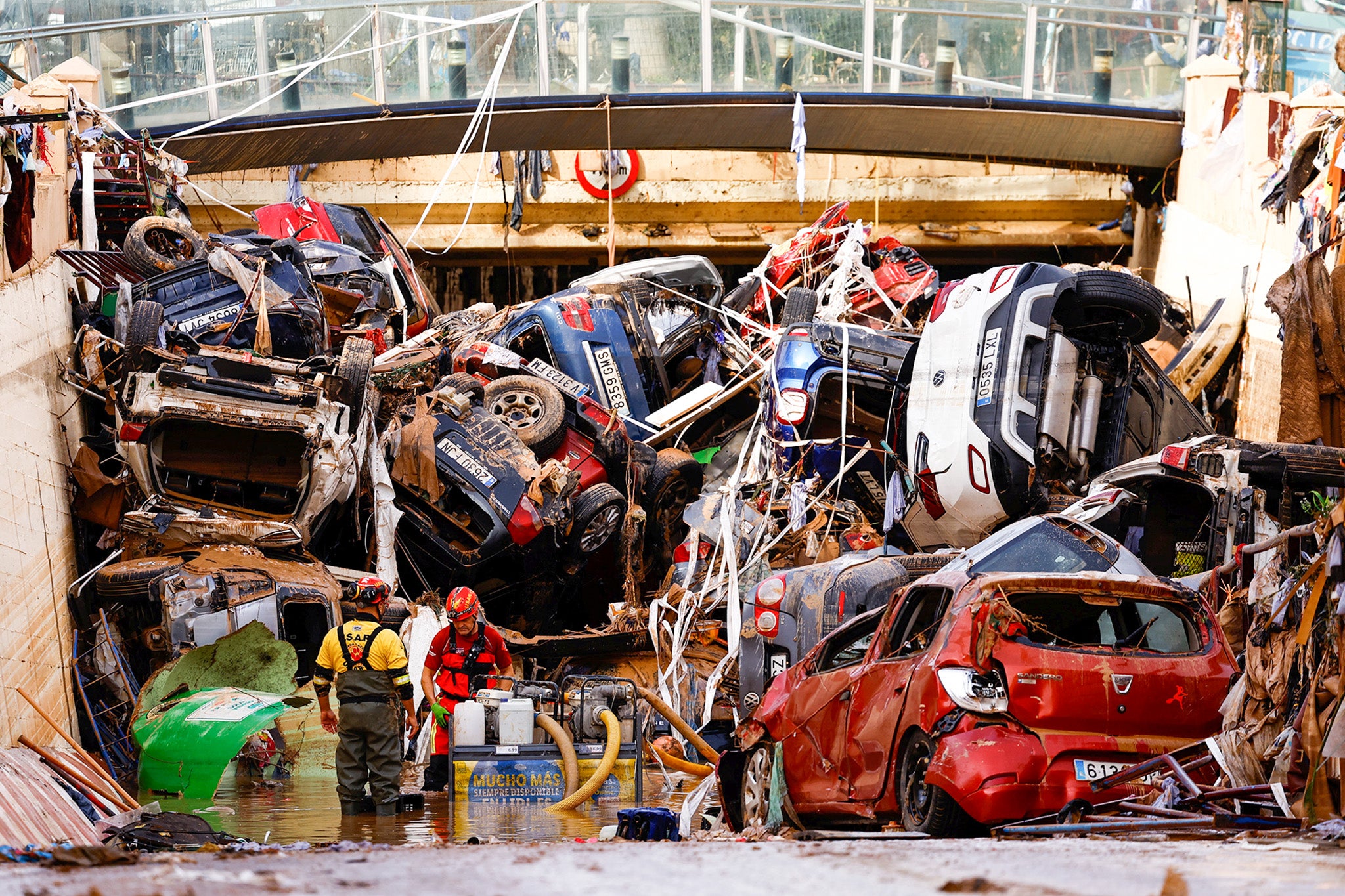 Firefighters pump out the floodwater out of a tunnel where vehicles are piled up in Alfafar, Valencia