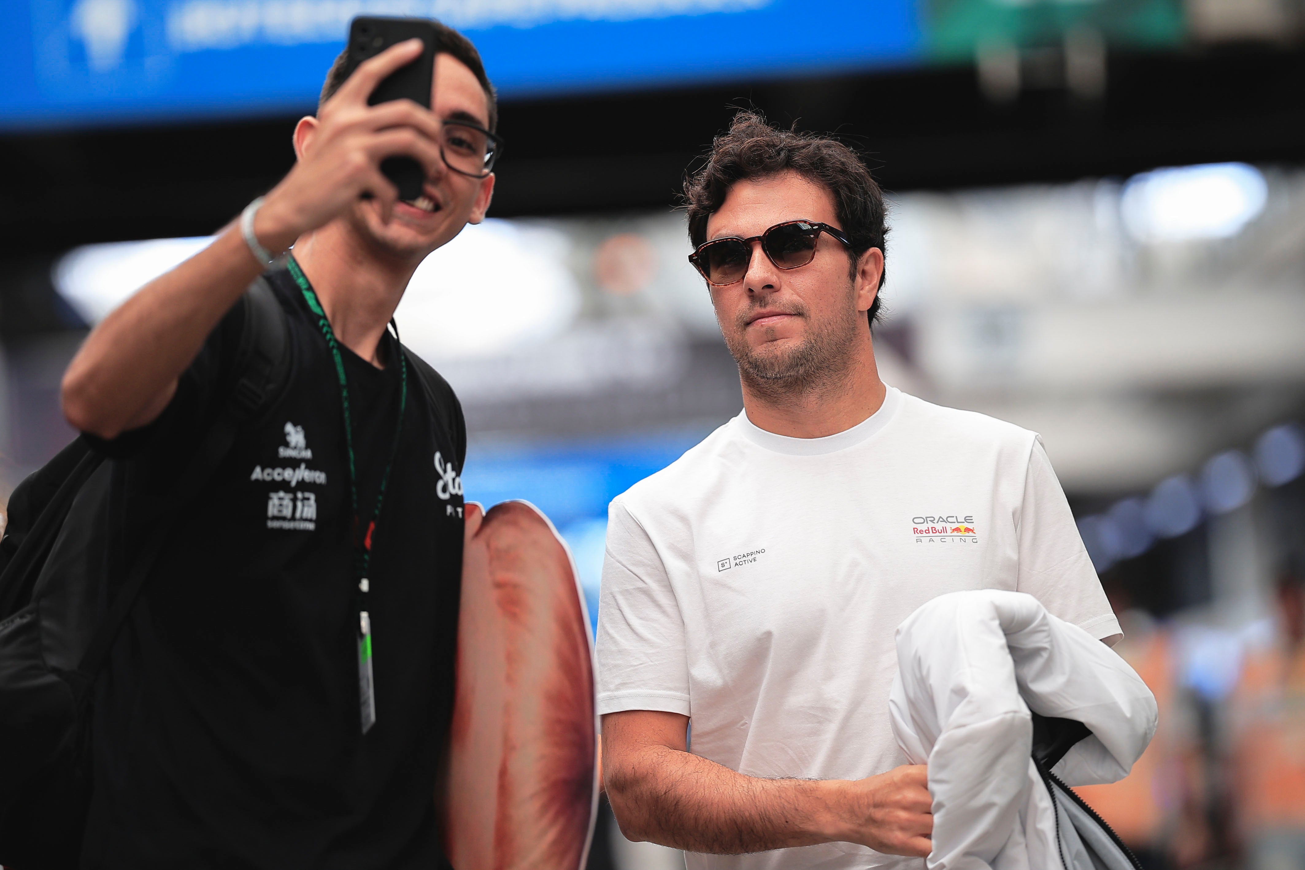 A fan takes a selfie with Red Bull driver Sergio Perez