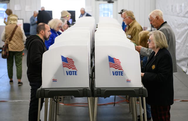 <p>Voters make selections at their voting booths inside an early voting site on October 17, 2024 in Hendersonville, North Carolina</p>