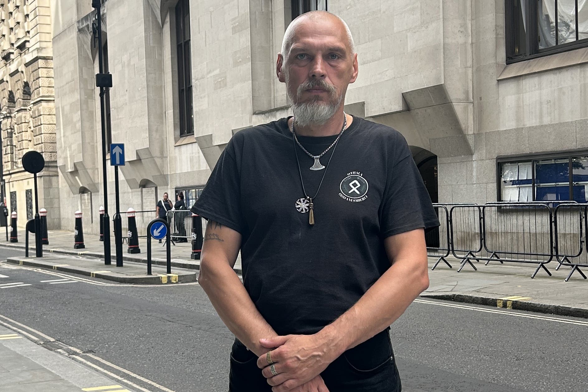 Piotr Kucharski posing outside the Old Bailey wearing articles associated with extreme right-wing ideology (Pol Allingham/PA)