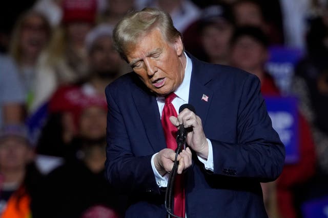<p>Republican presidential nominee former President Donald Trump unhooks the microphone as he speaks in Milwaukee</p>