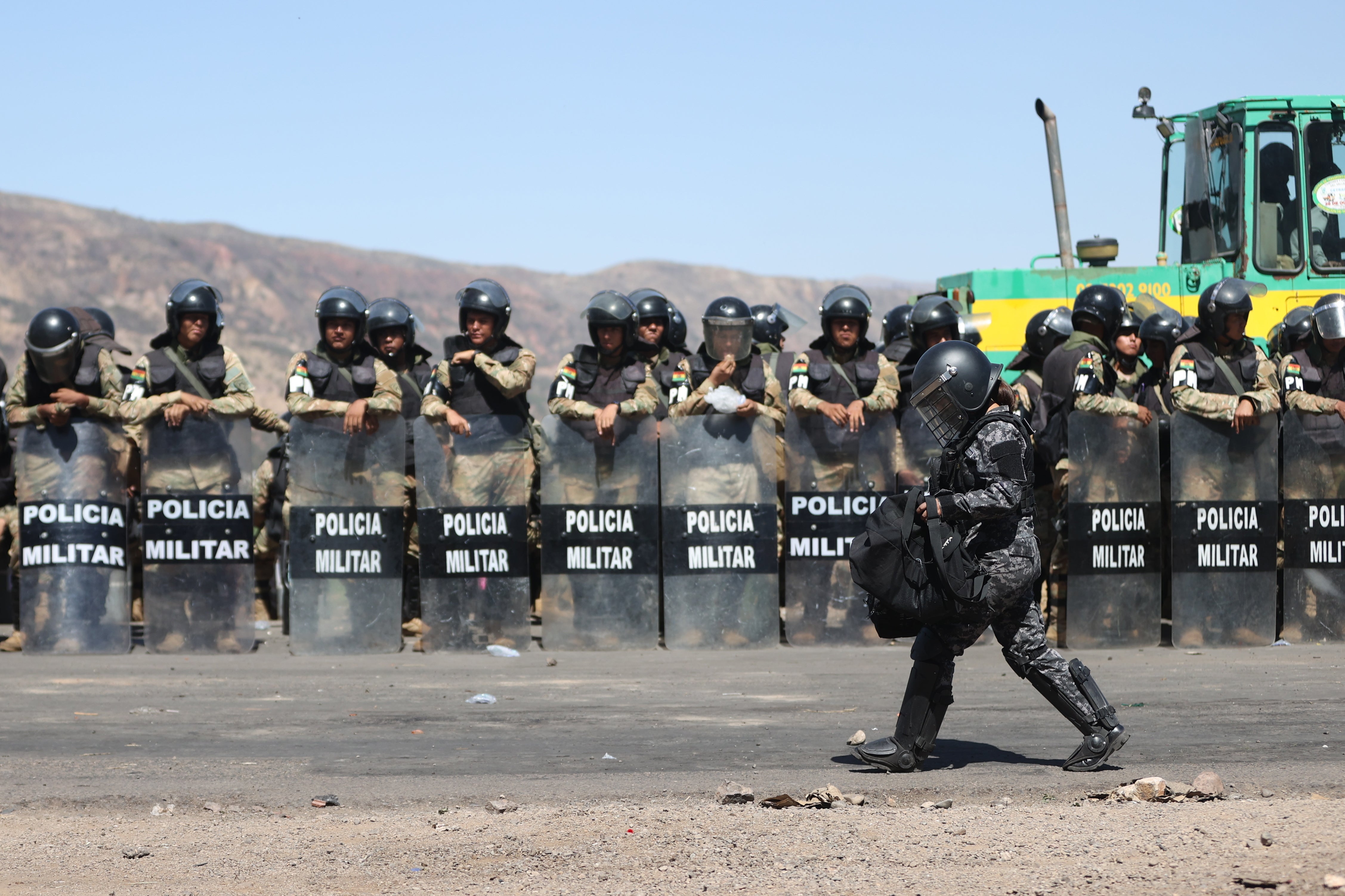 <p>Members of the Bolivian Military Police guard a road blocked by supporters of former Bolivian President Evo Morales </p>