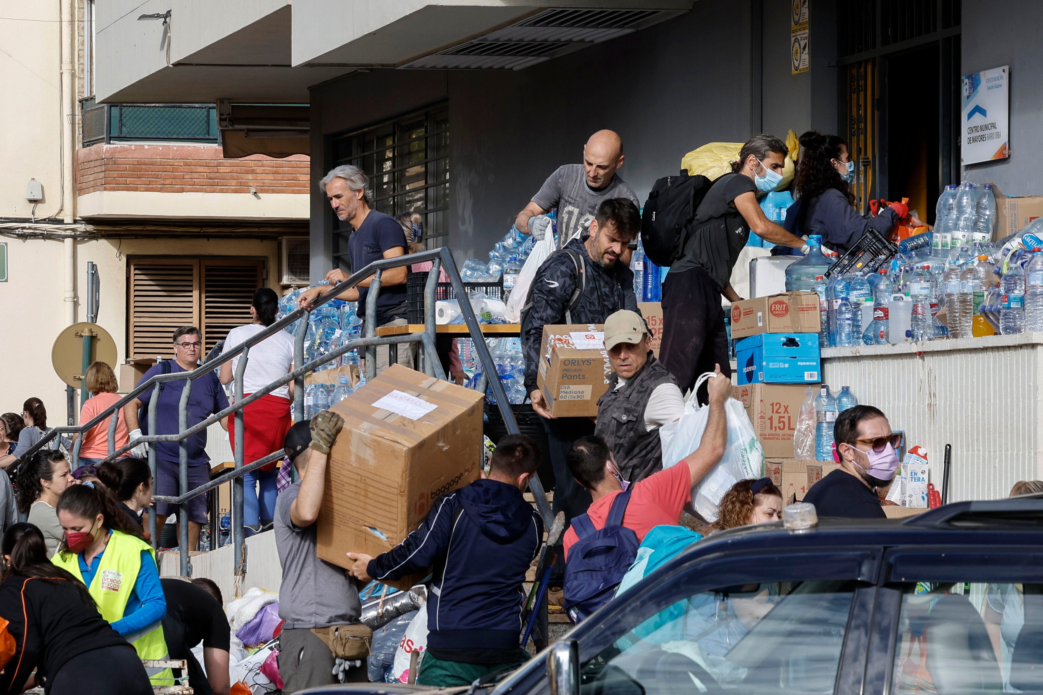 Several volunteers work at an aid delivery center in the town of Alfafar, in Valencia