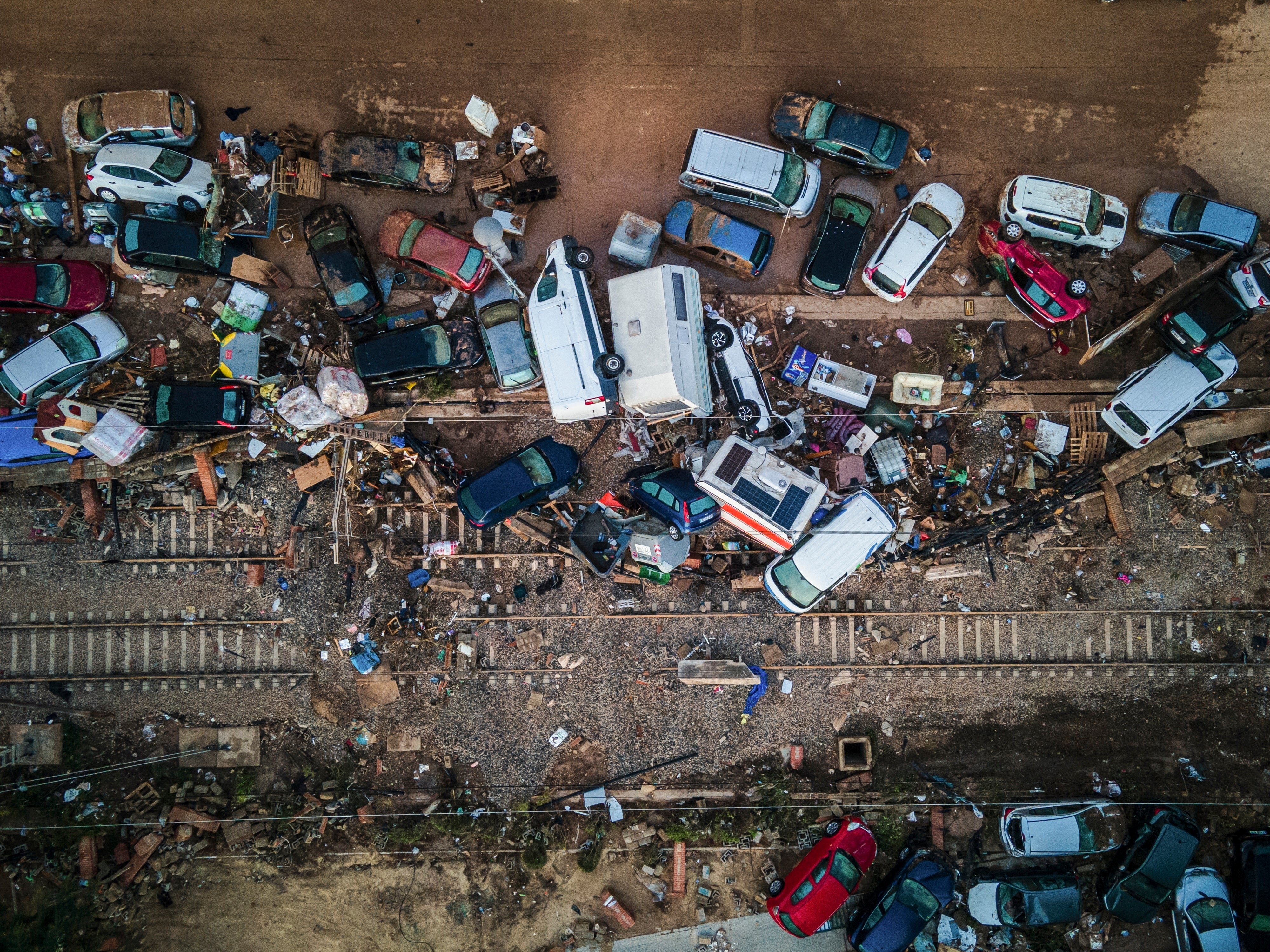 Vehicles pile up on the train tracks in the aftermath of flooding