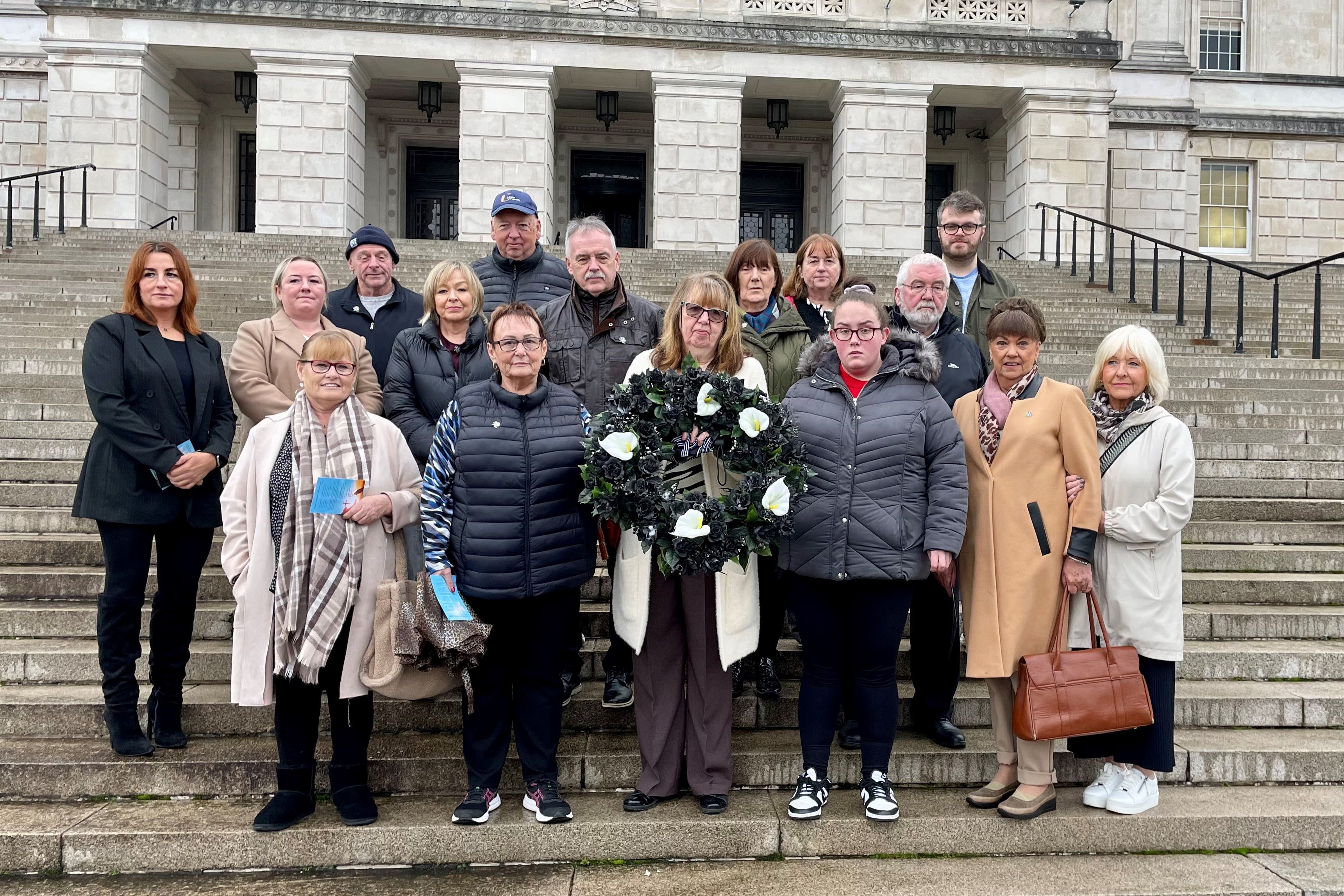 Dympna Kerr, the sister of Disappeared victim Columba McVeigh (holding wreath) joins families of the Disappeared victims of the Northern Ireland Troubles taking part in their annual All Souls Day silent walk at Stormont to remember the five victims whose remains are yet to be found. Picture date: Saturday November 2, 2024.